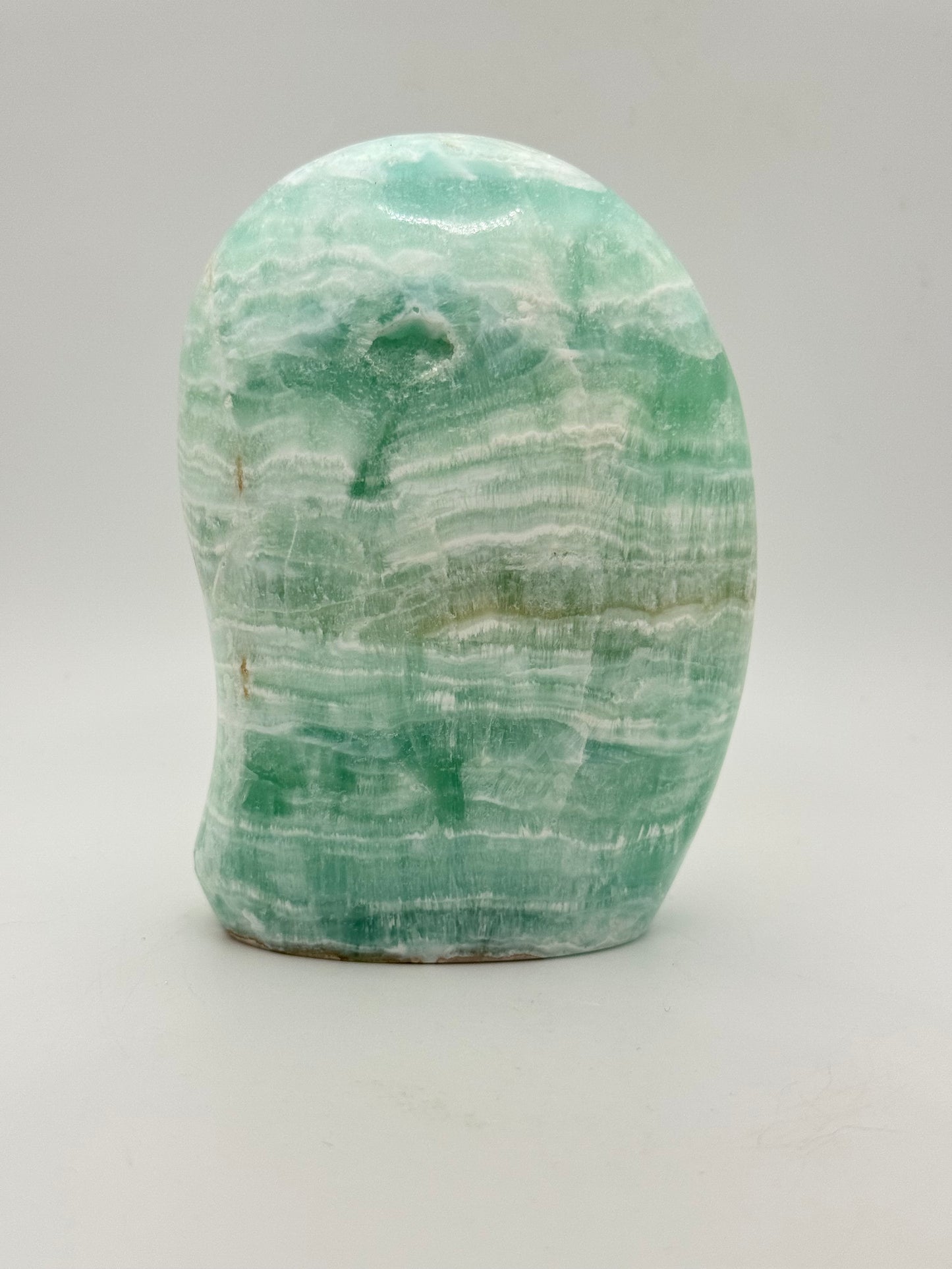 Caribbean calcite polished crystal free form in the shape of a dome.