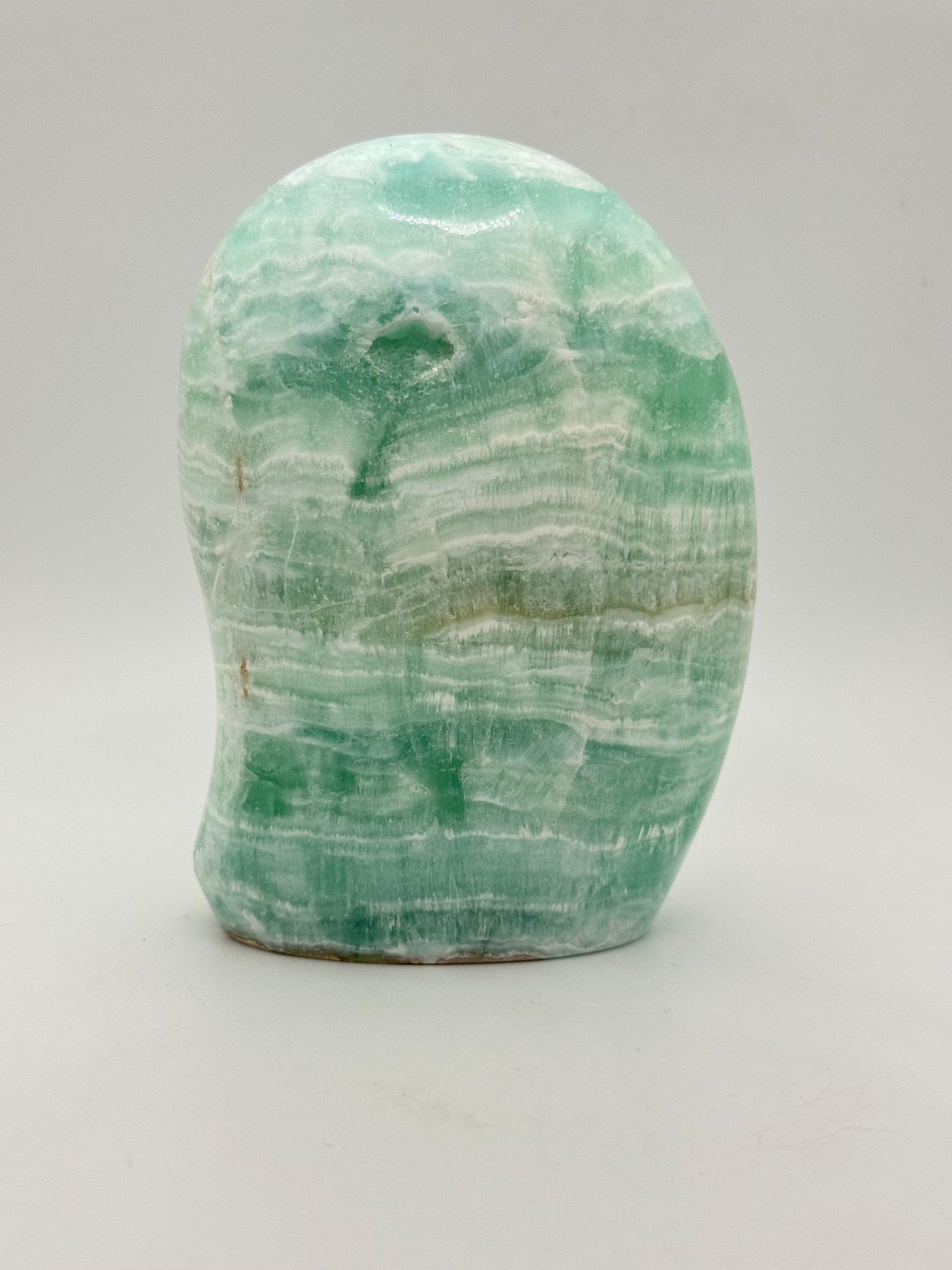 Caribbean calcite polished crystal free form in the shape of a dome.