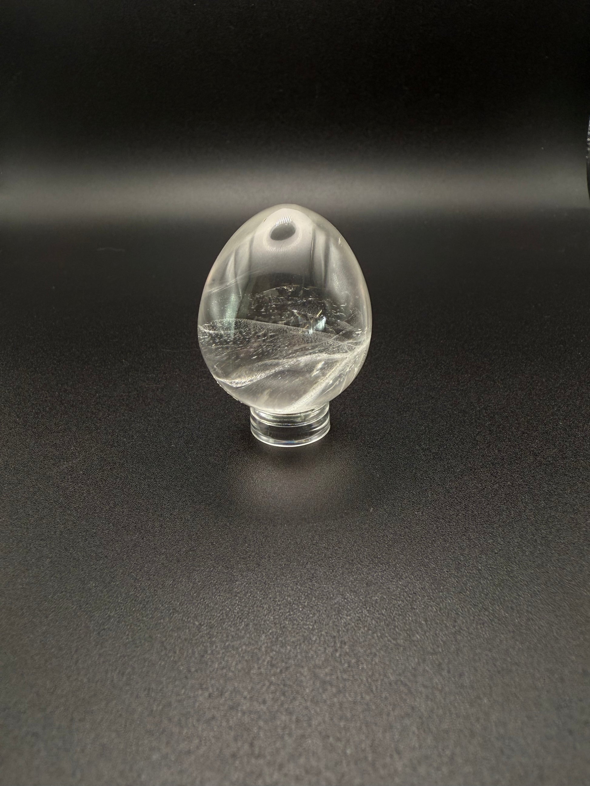 Clear quartz polished crystal in the shape of an egg.