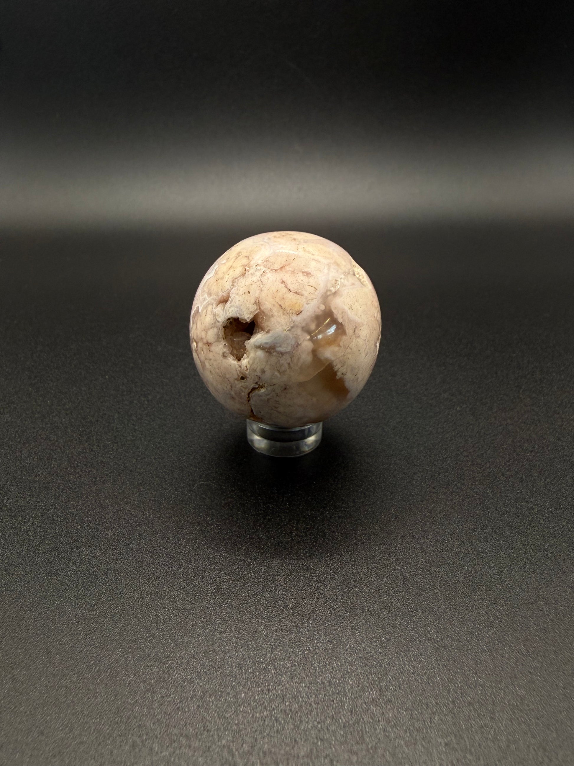 Flower agate polished crystal in the shape of a sphere.