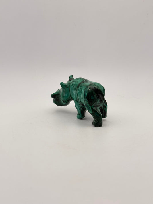 Vibrant green malachite stone carving of a rhino.