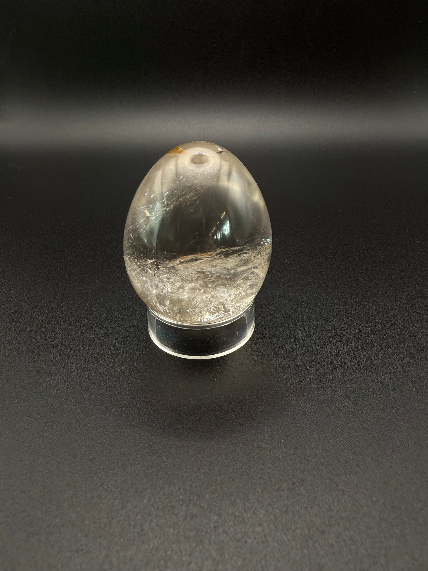 Clear quartz polished crystal thats egg shaped.