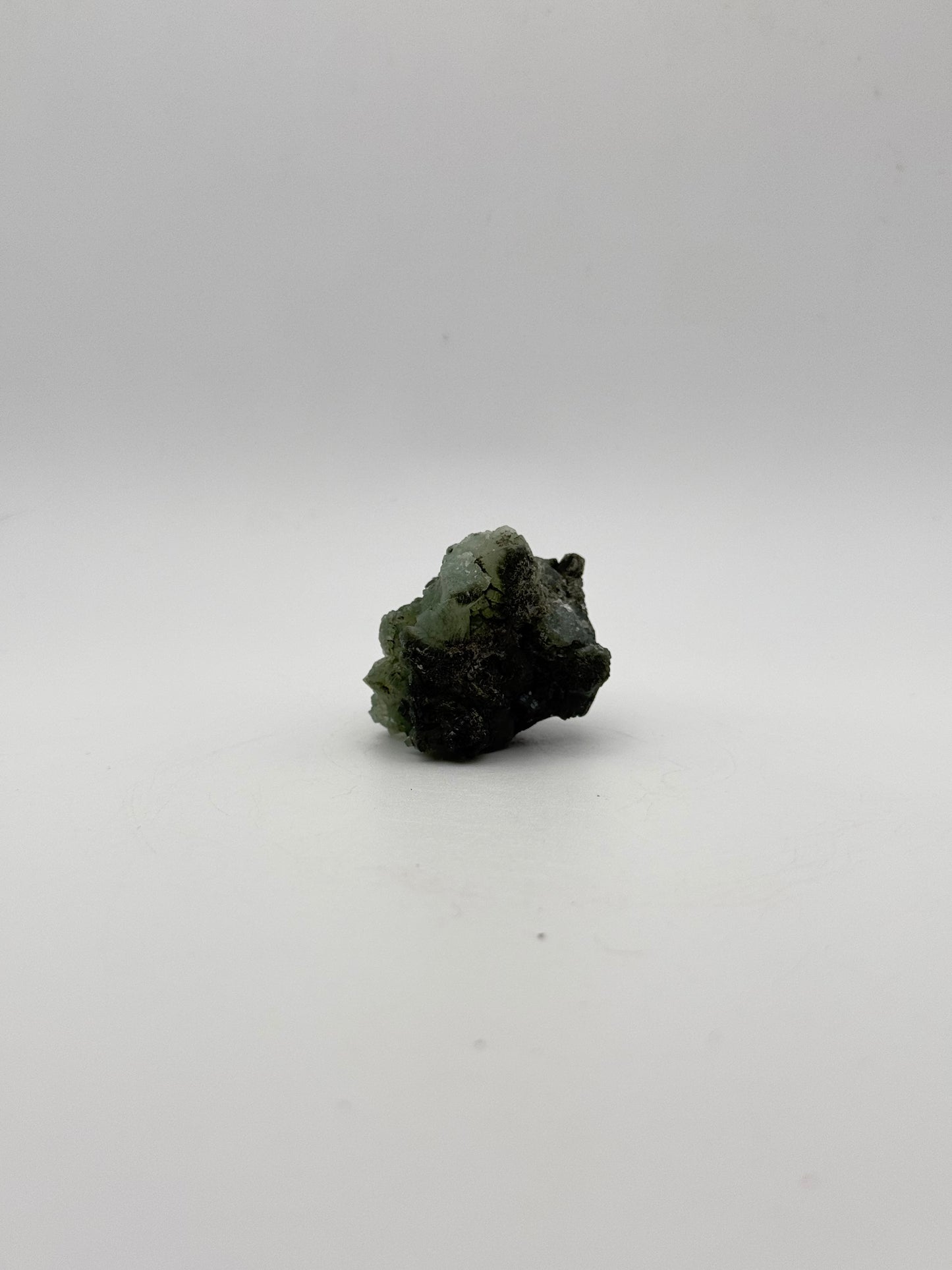 Raw Prehnite specimen with amazing green color.