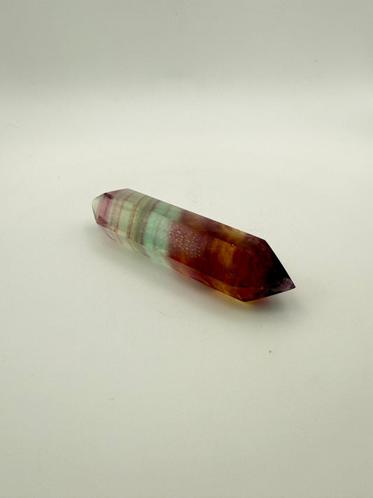 Rainbow Fluorite polished crystal in the shape of a double term.