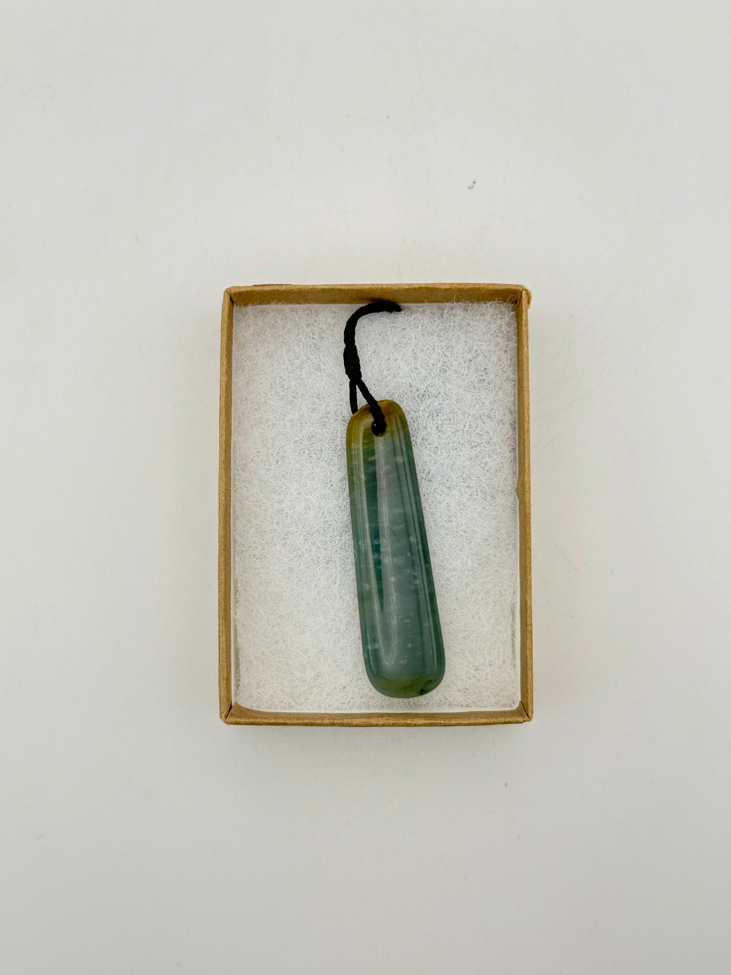 Green Jade pendant with string necklace.