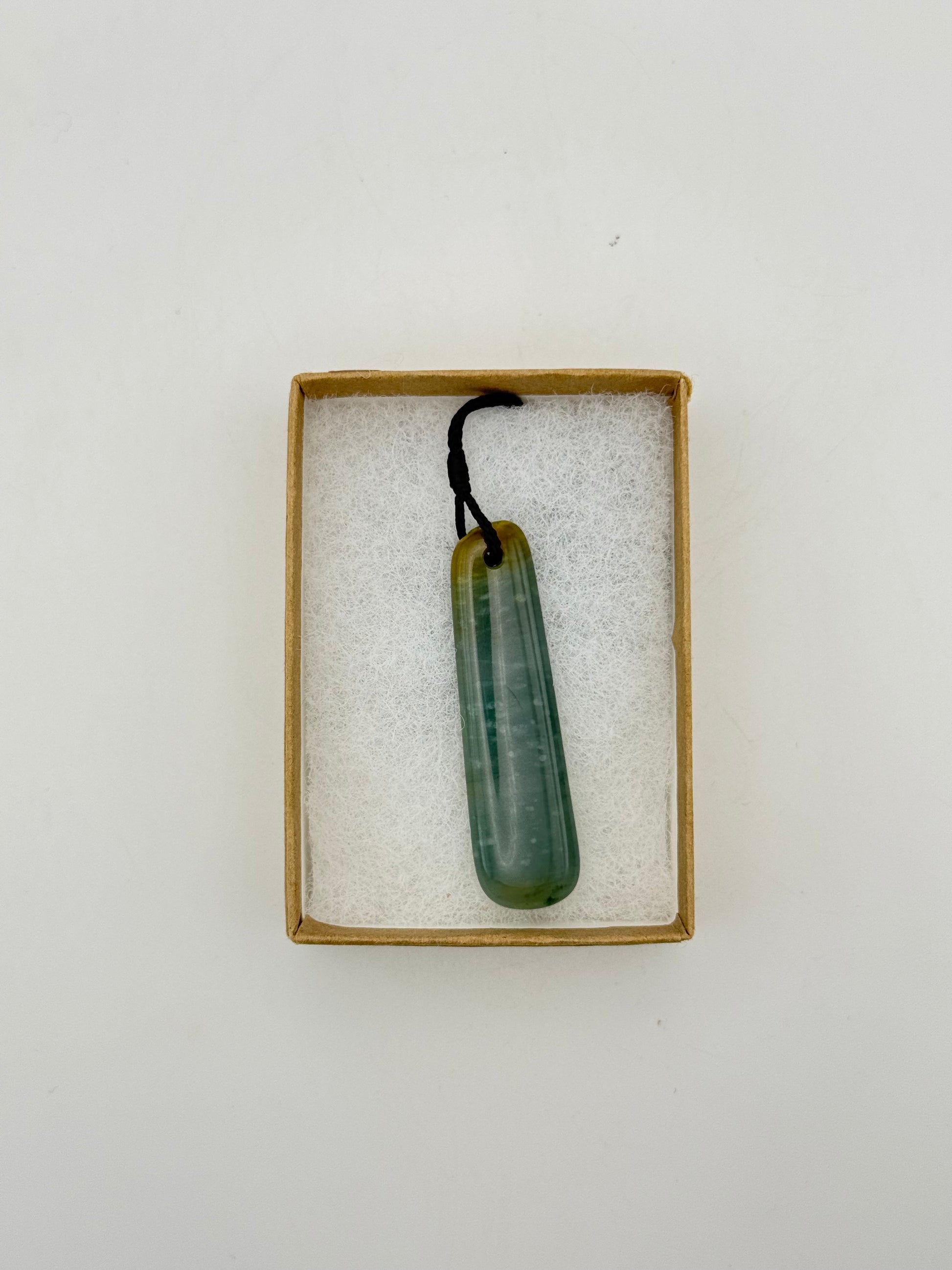 Green Jade pendant with string necklace.