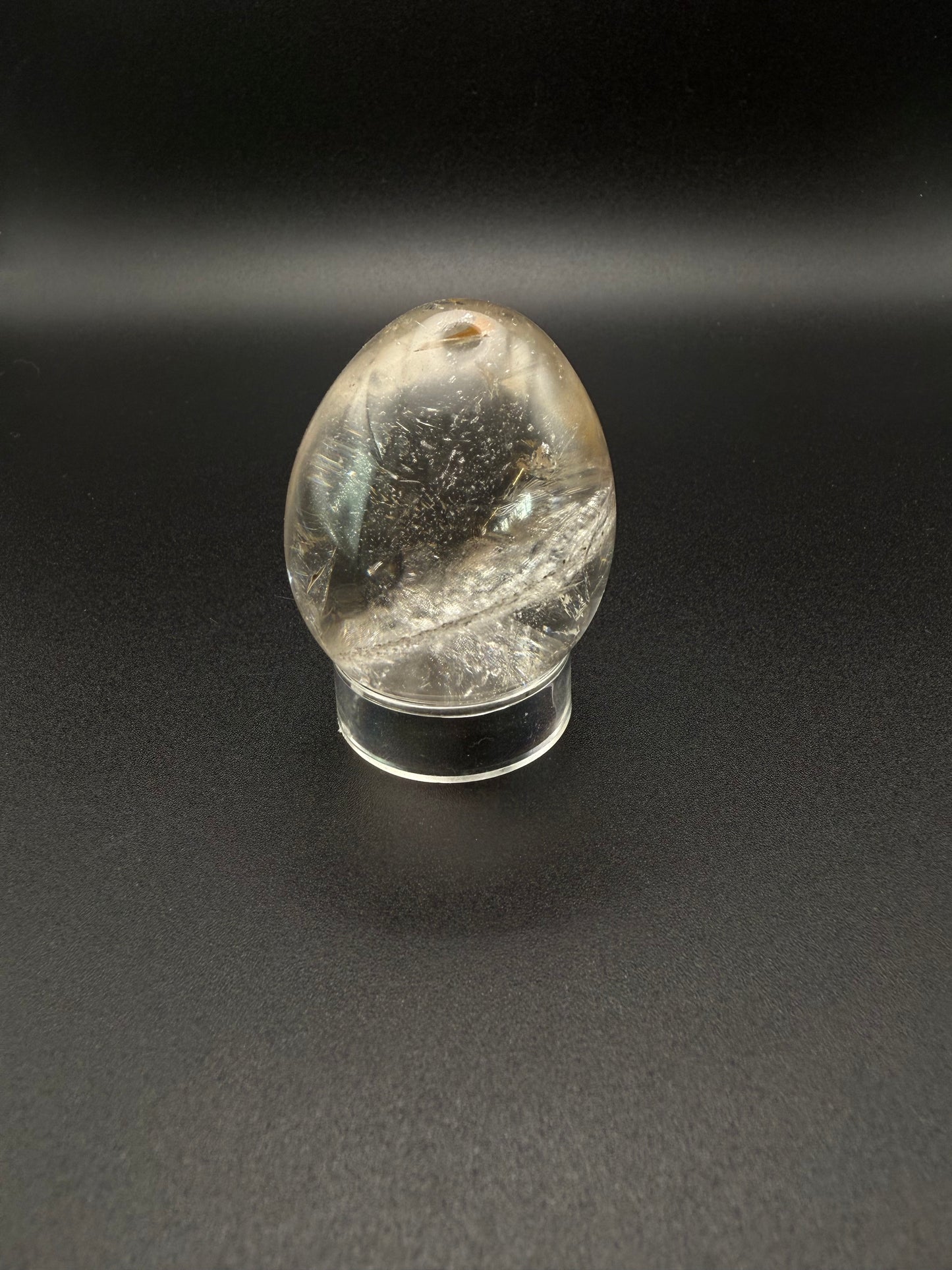 Clear quartz polished crystal thats egg shaped.