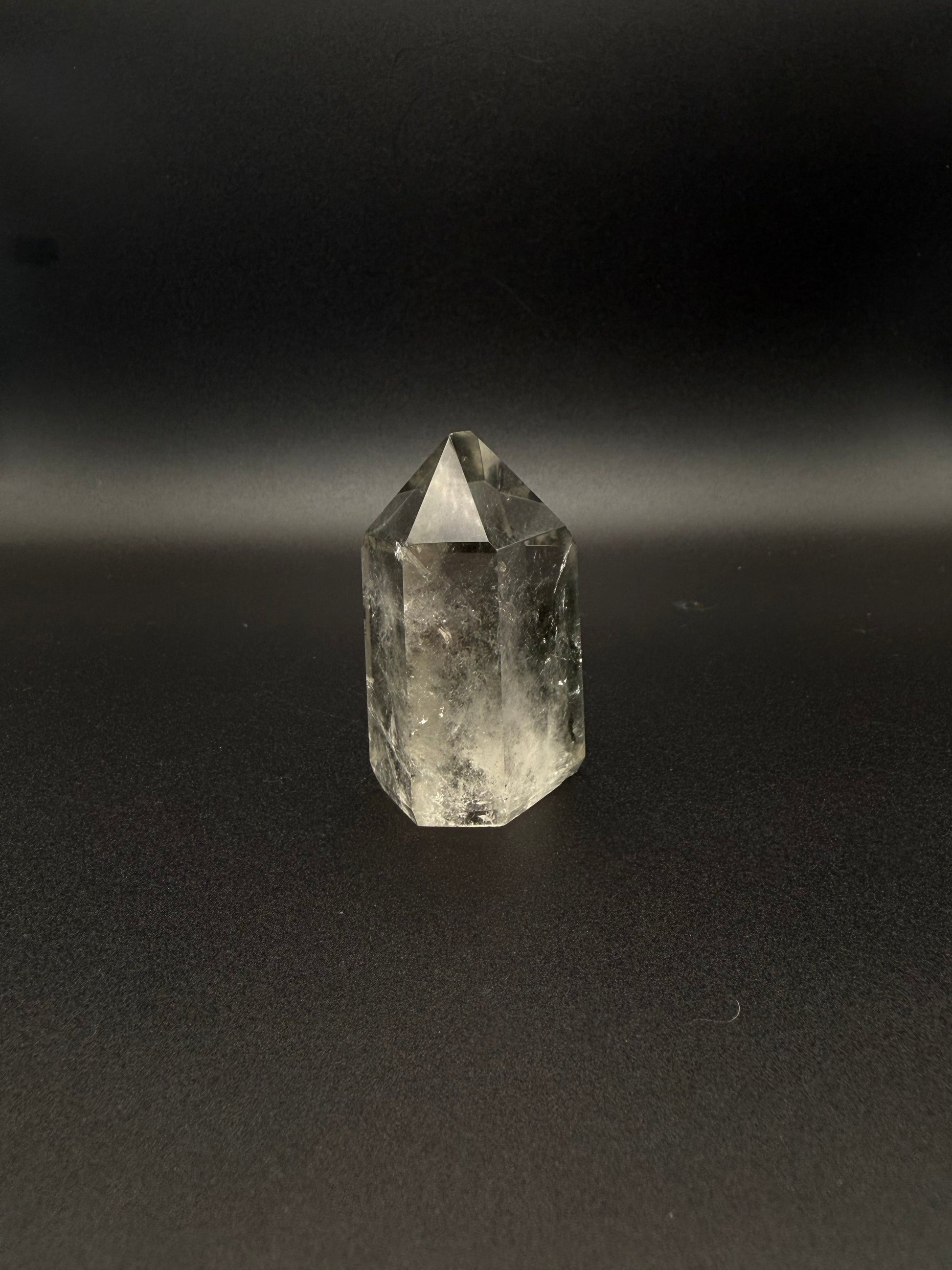 Polished garden quartz crystal tower with six sides.
