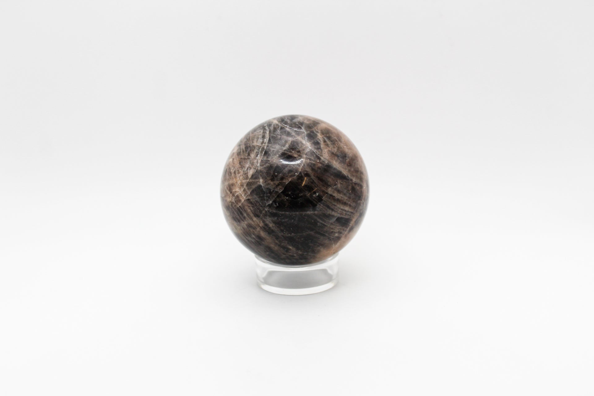 A polished black moonstone sphere.
