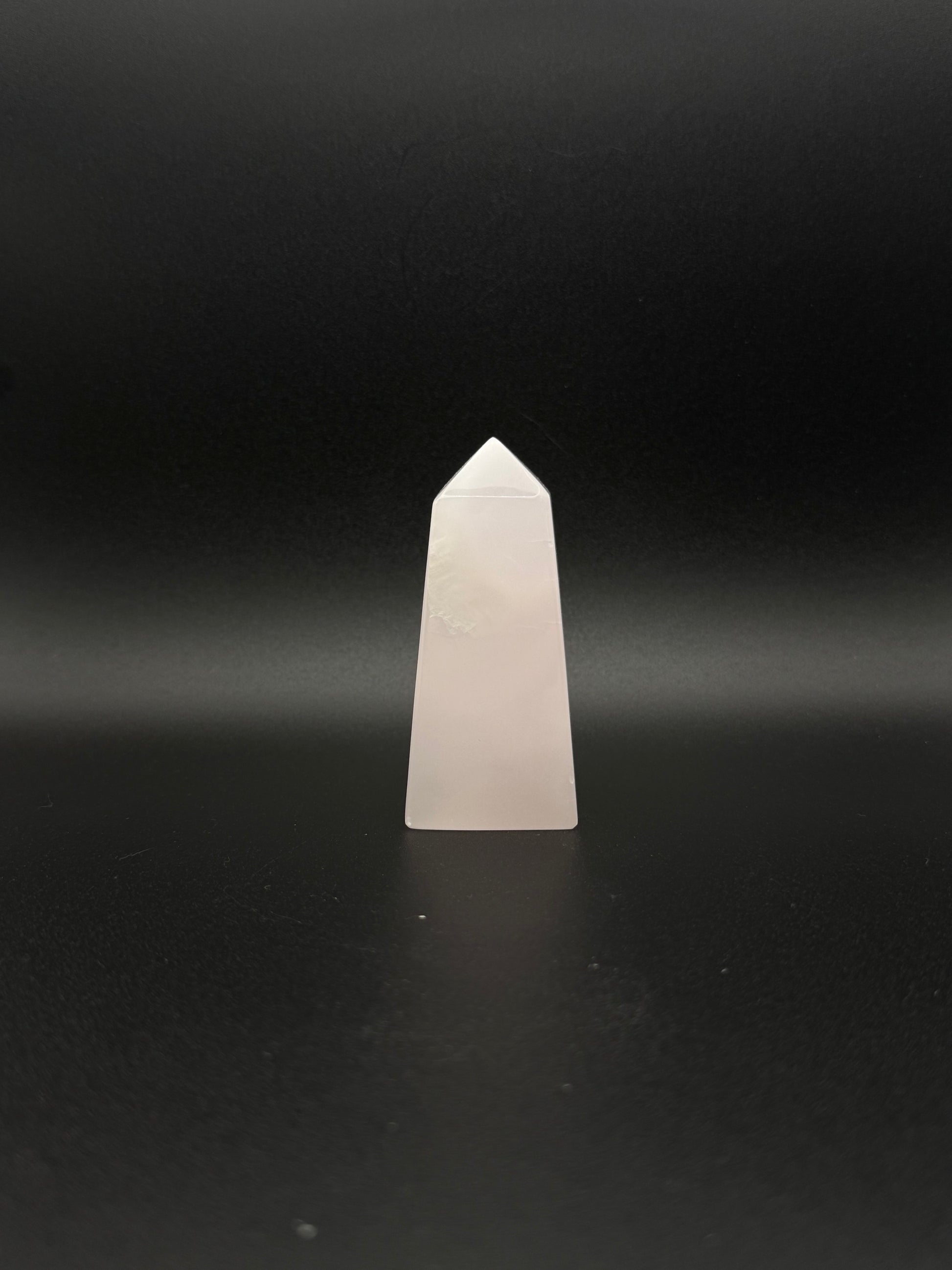 Polished pink calcite tower. Pink calcite glows under uv light.