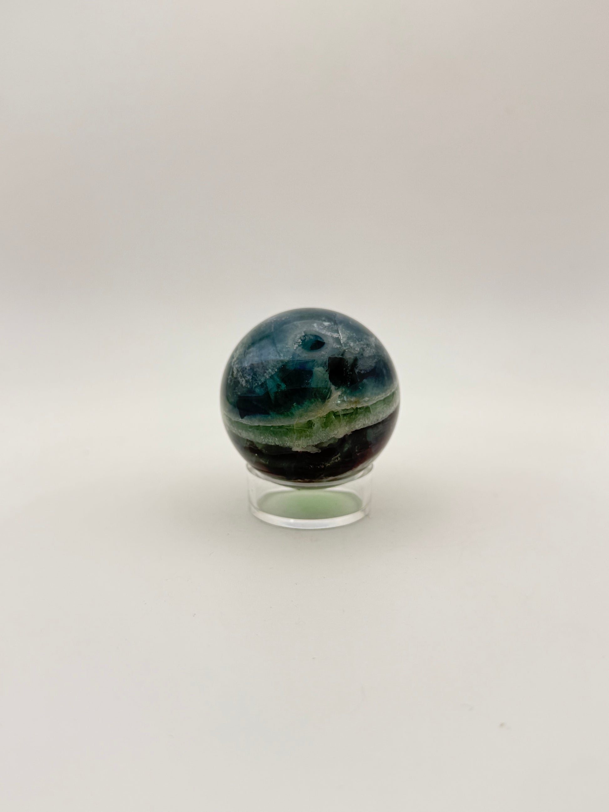 Rainbow Fluorite polished crystal sphere.