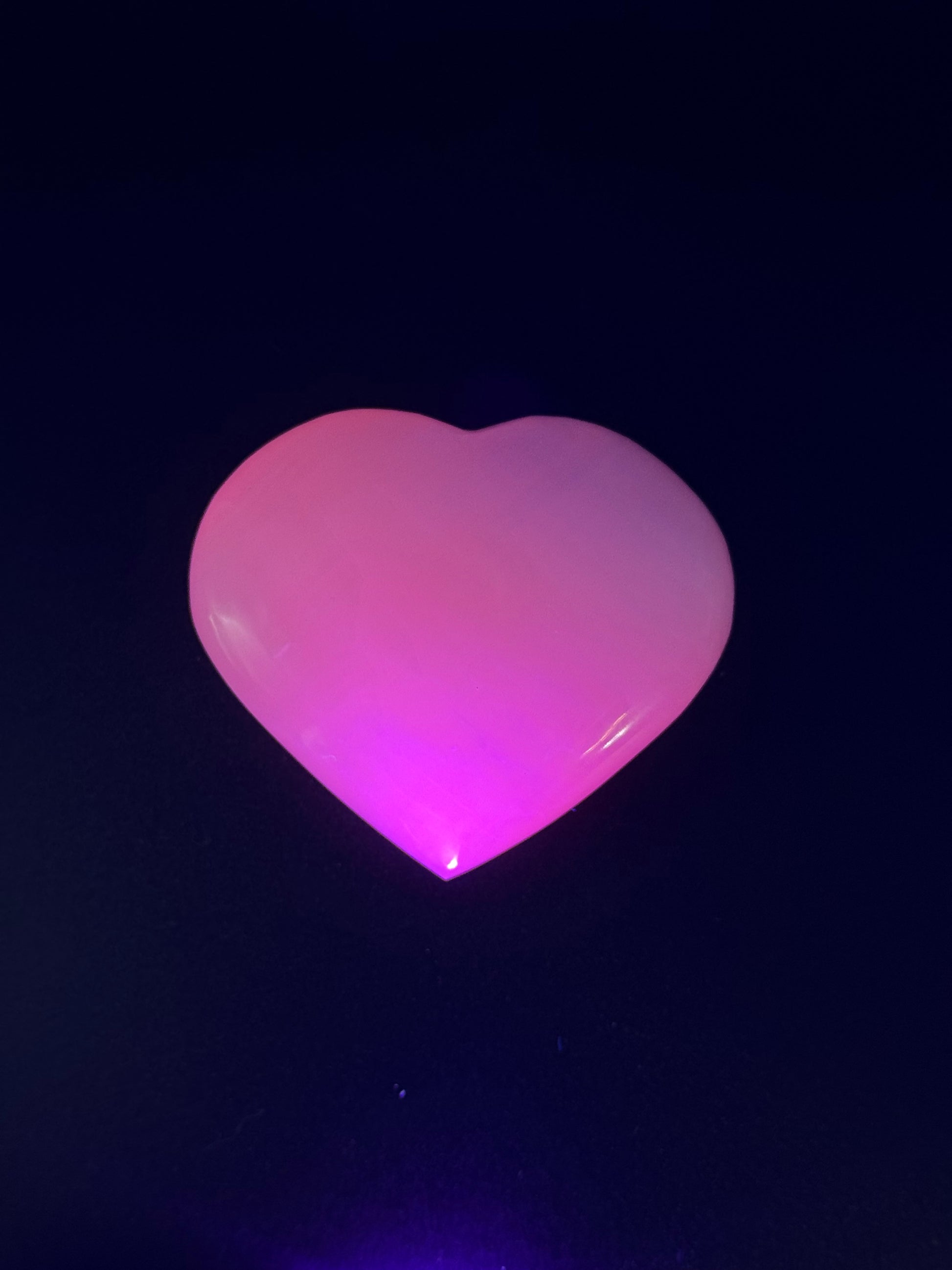 Polished pink calcite heart. Pink calcite glows under uv light.