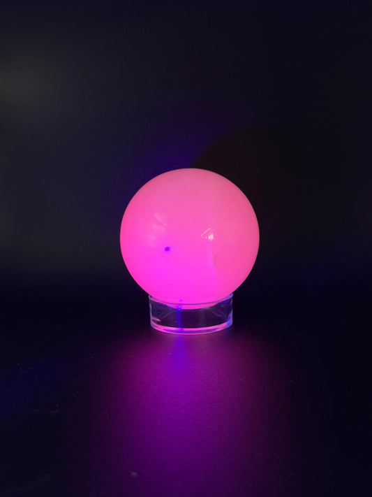 Polished pink calcite sphere. Pink calcite glows under uv light.