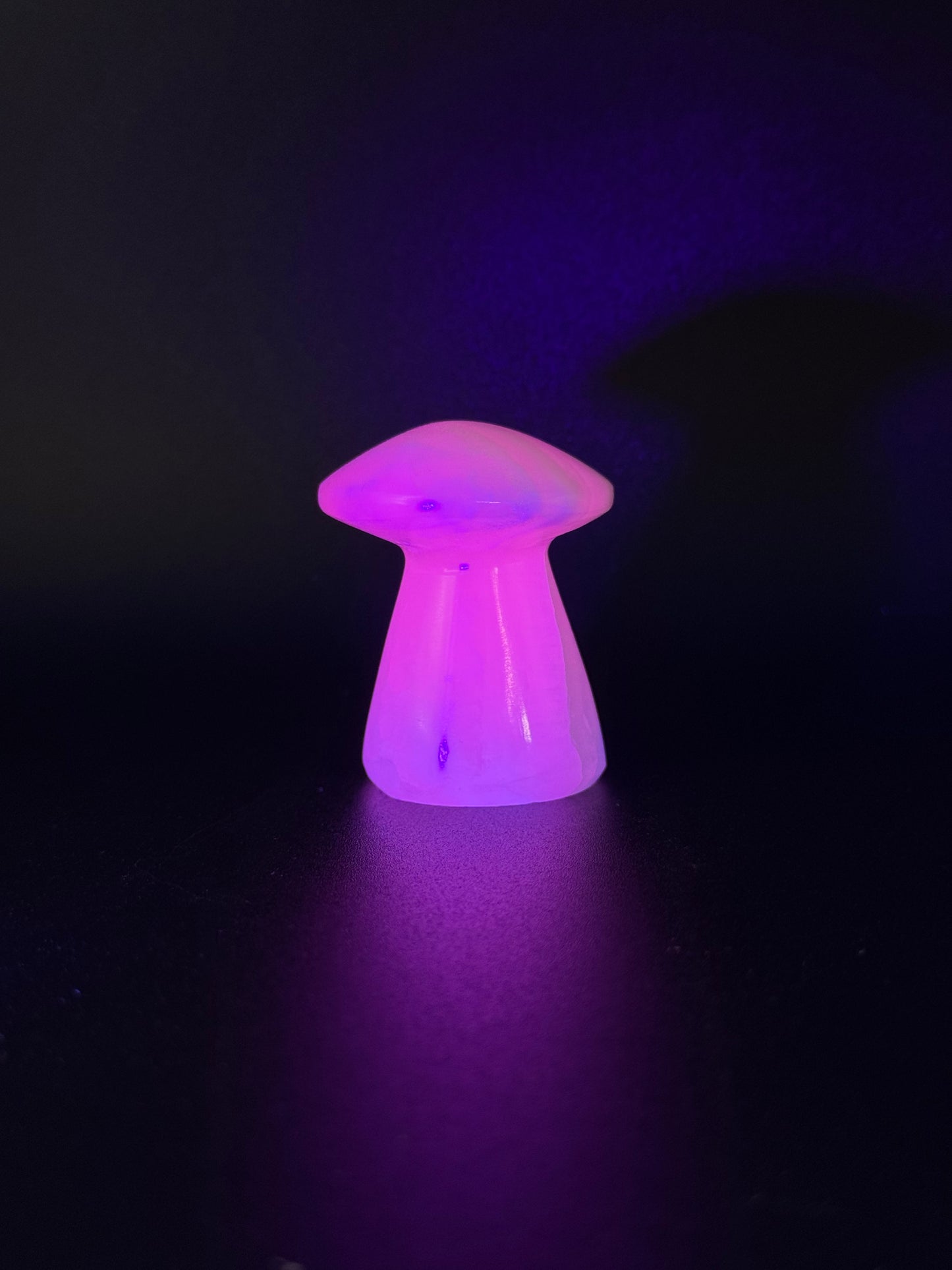 Polished pink calcite mushroom. Pink calcite glows under uv light.
