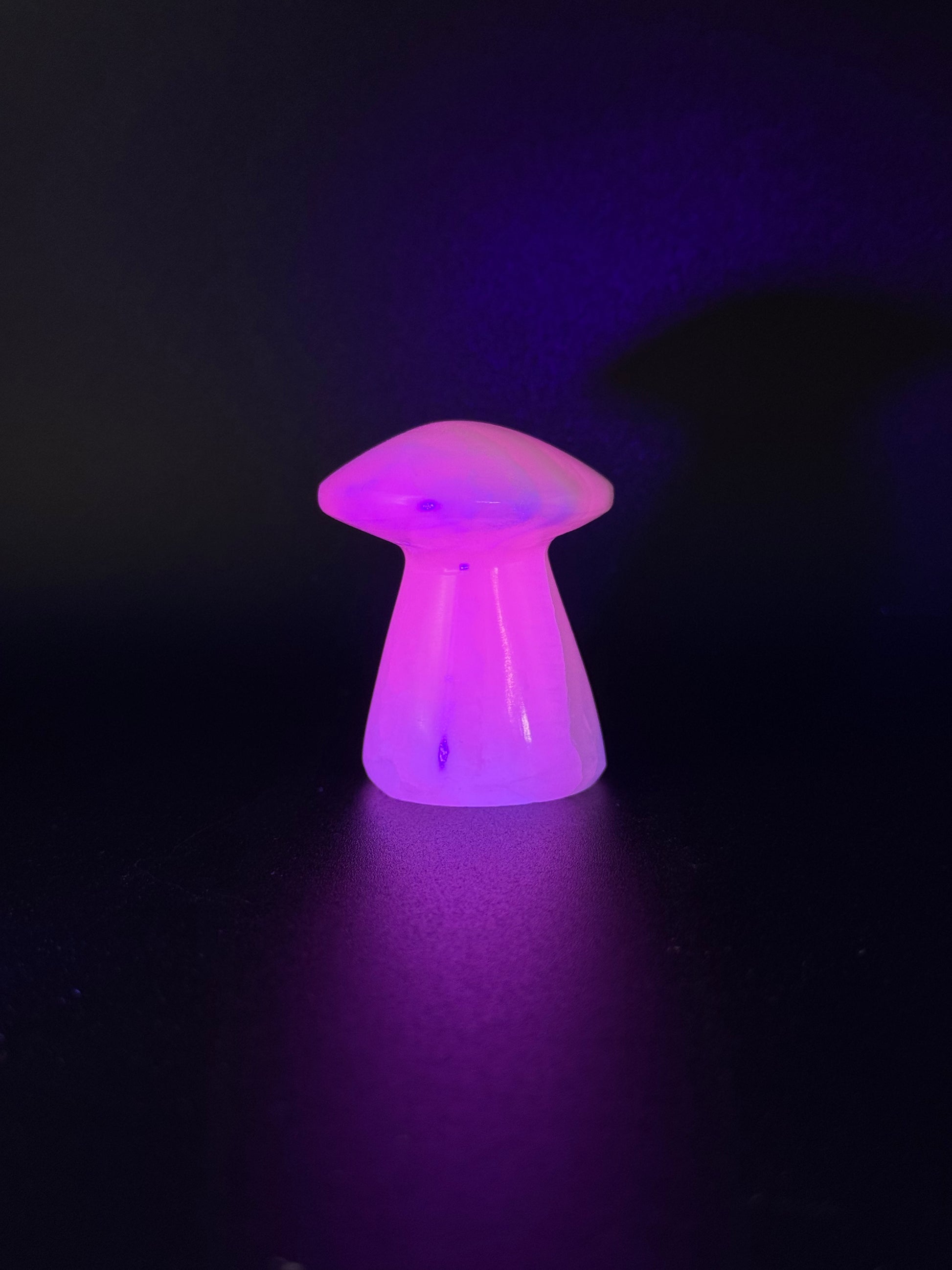 Polished pink calcite mushroom. Pink calcite glows under uv light.