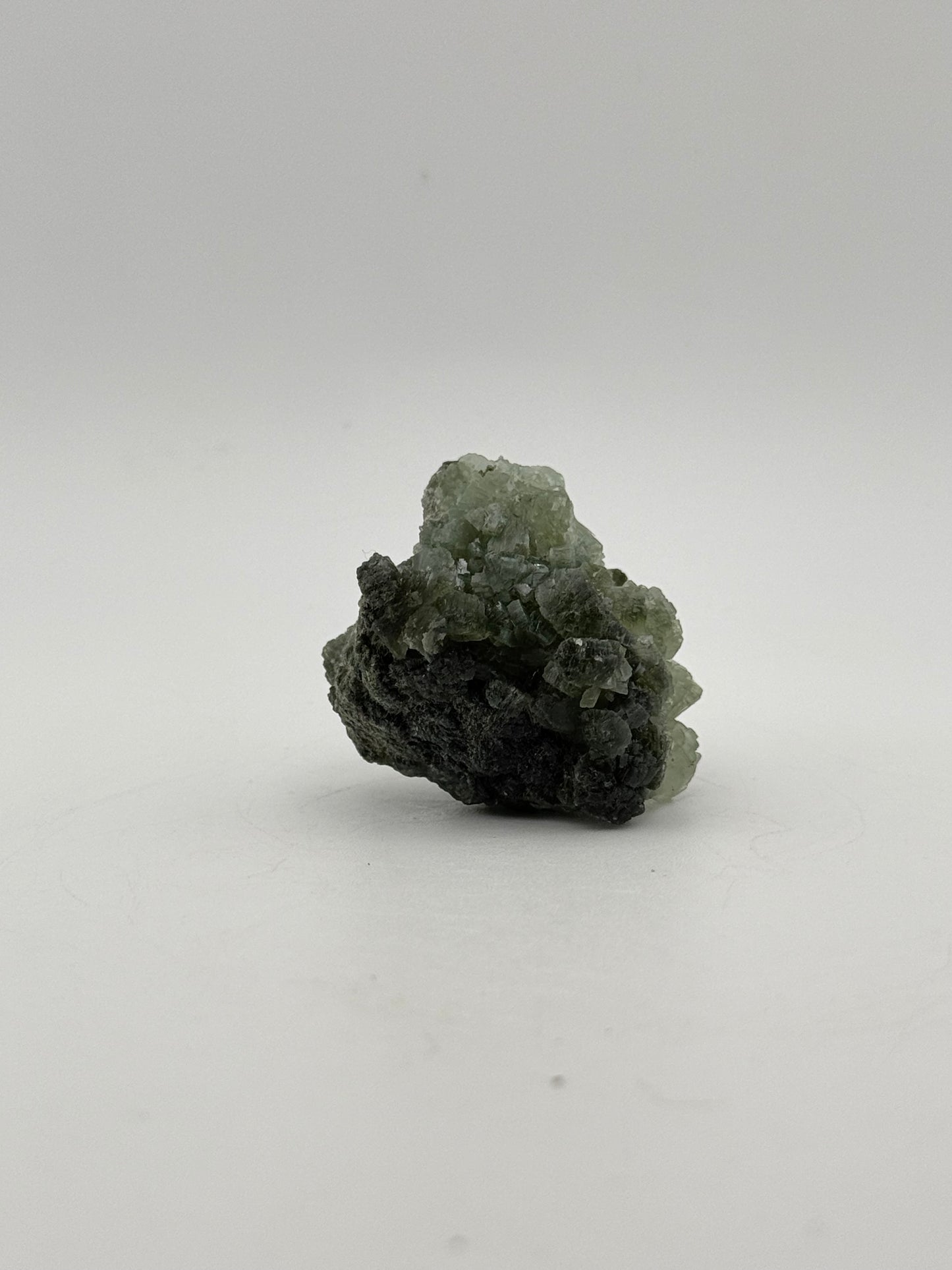 Raw Prehnite specimen with amazing green color.