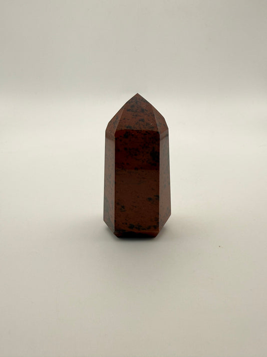 Polished mahogany obsidian tower with six sides.