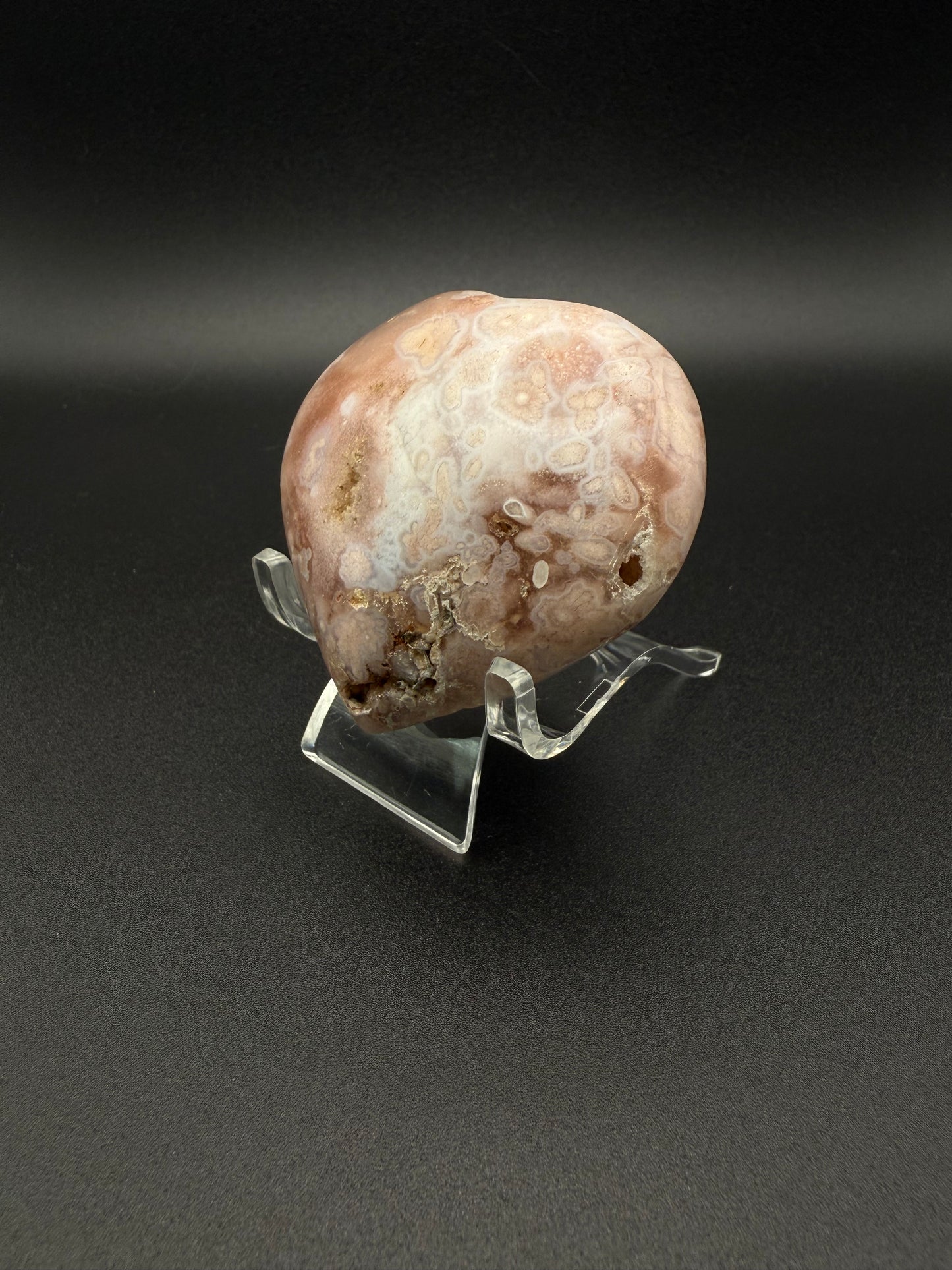 Flower agate polished crystal in the shape of a heart.