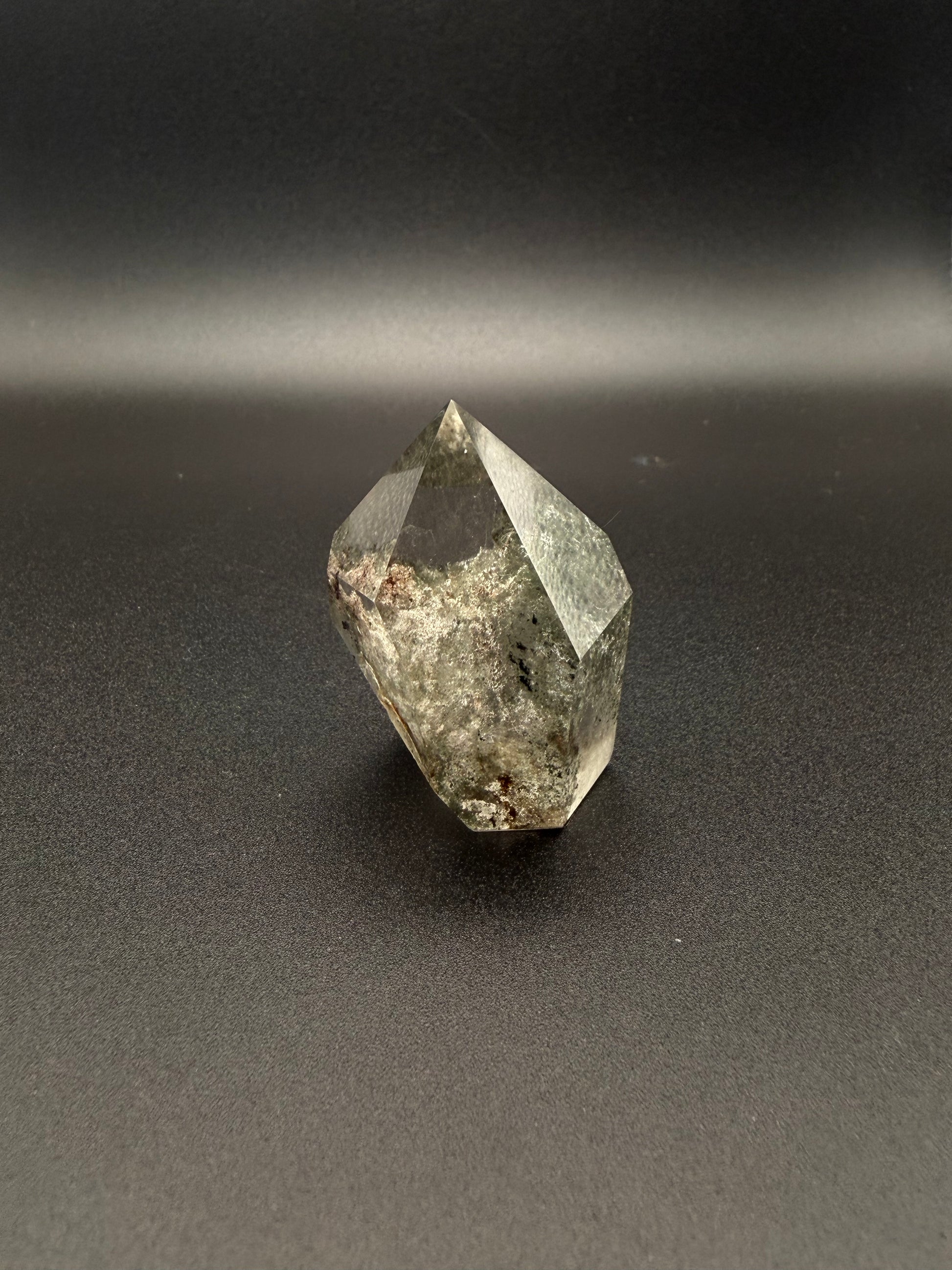 Polished garden quartz crystal tower with six sides.