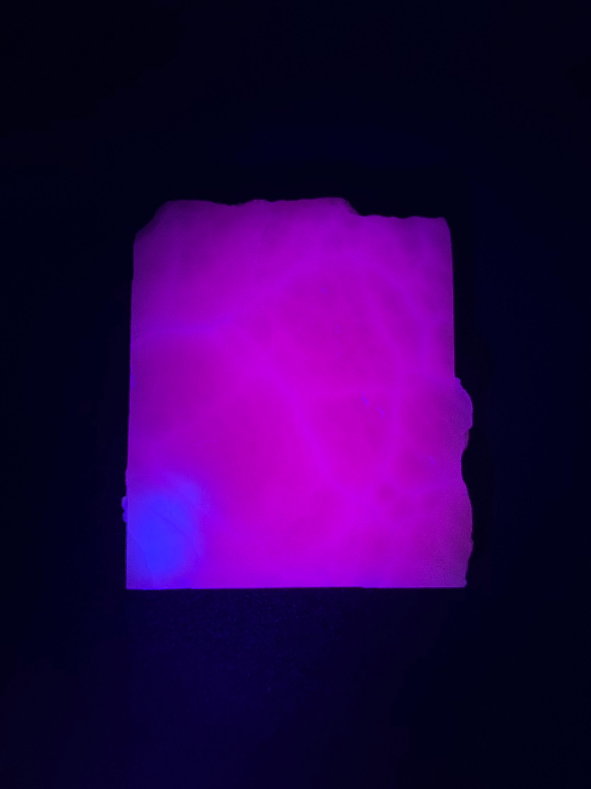 Polished pink calcite slab. Pink calcite glows under uv light.