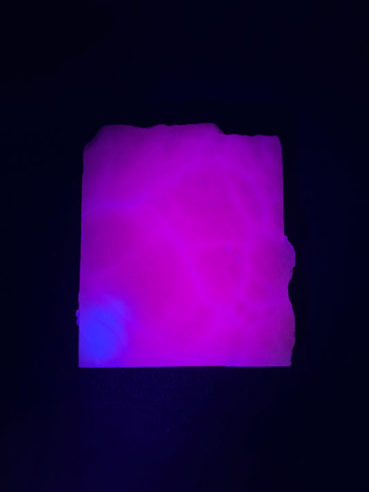 Polished pink calcite slab. Pink calcite glows under uv light.