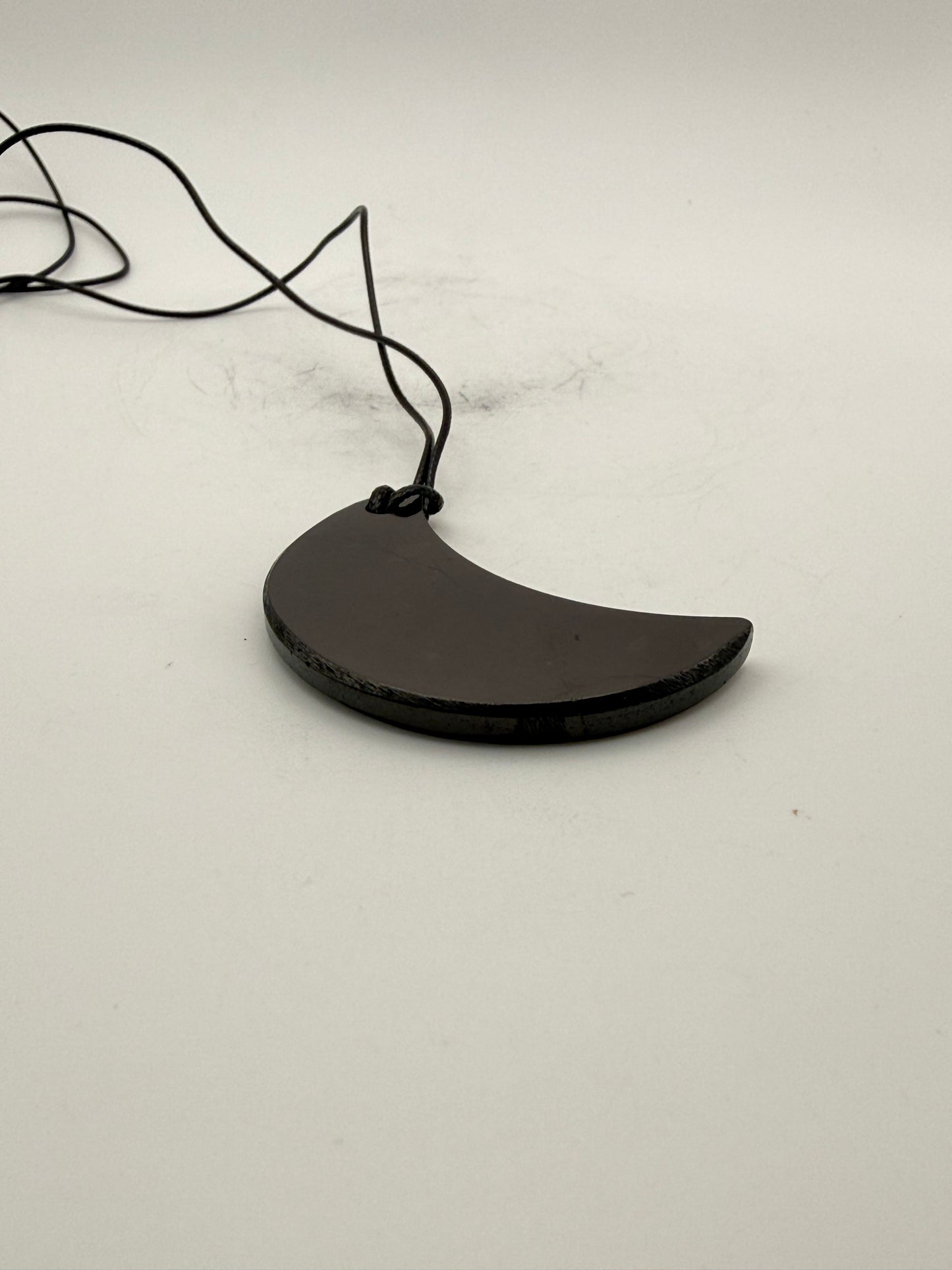 Shungite half moon pendant.