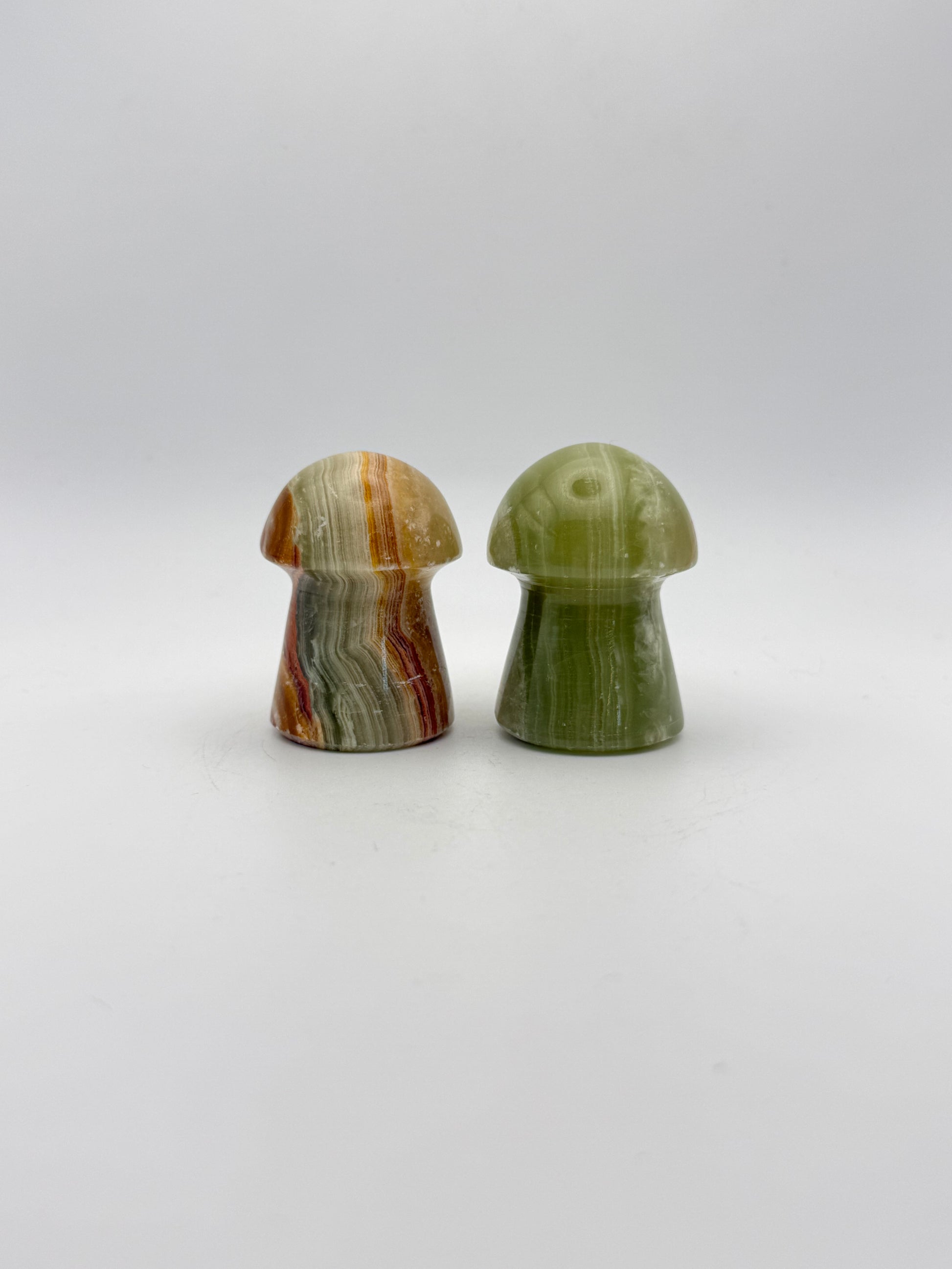 Two onyx mushroom-shaped stones.