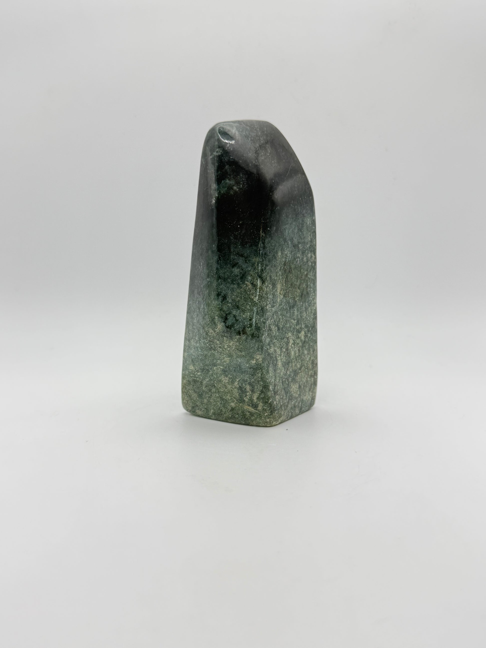 Polished green jade free form.