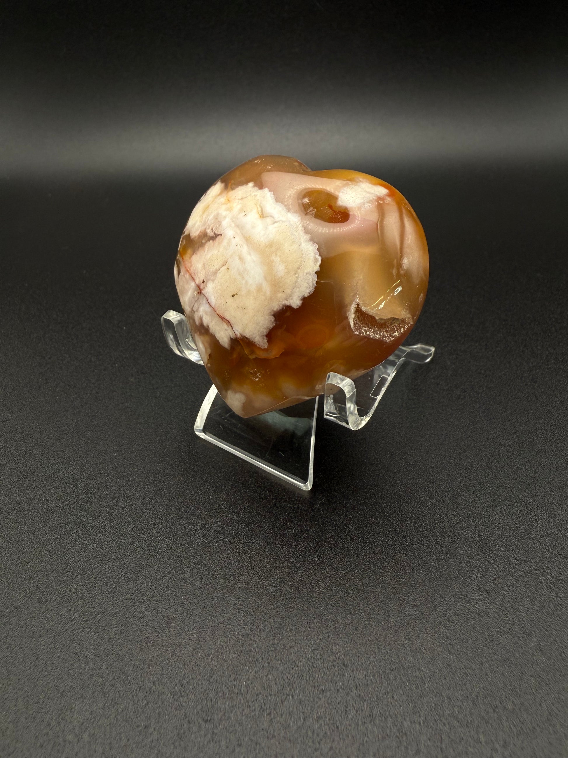 Flower Agate polished crystal in the shape of a heart.