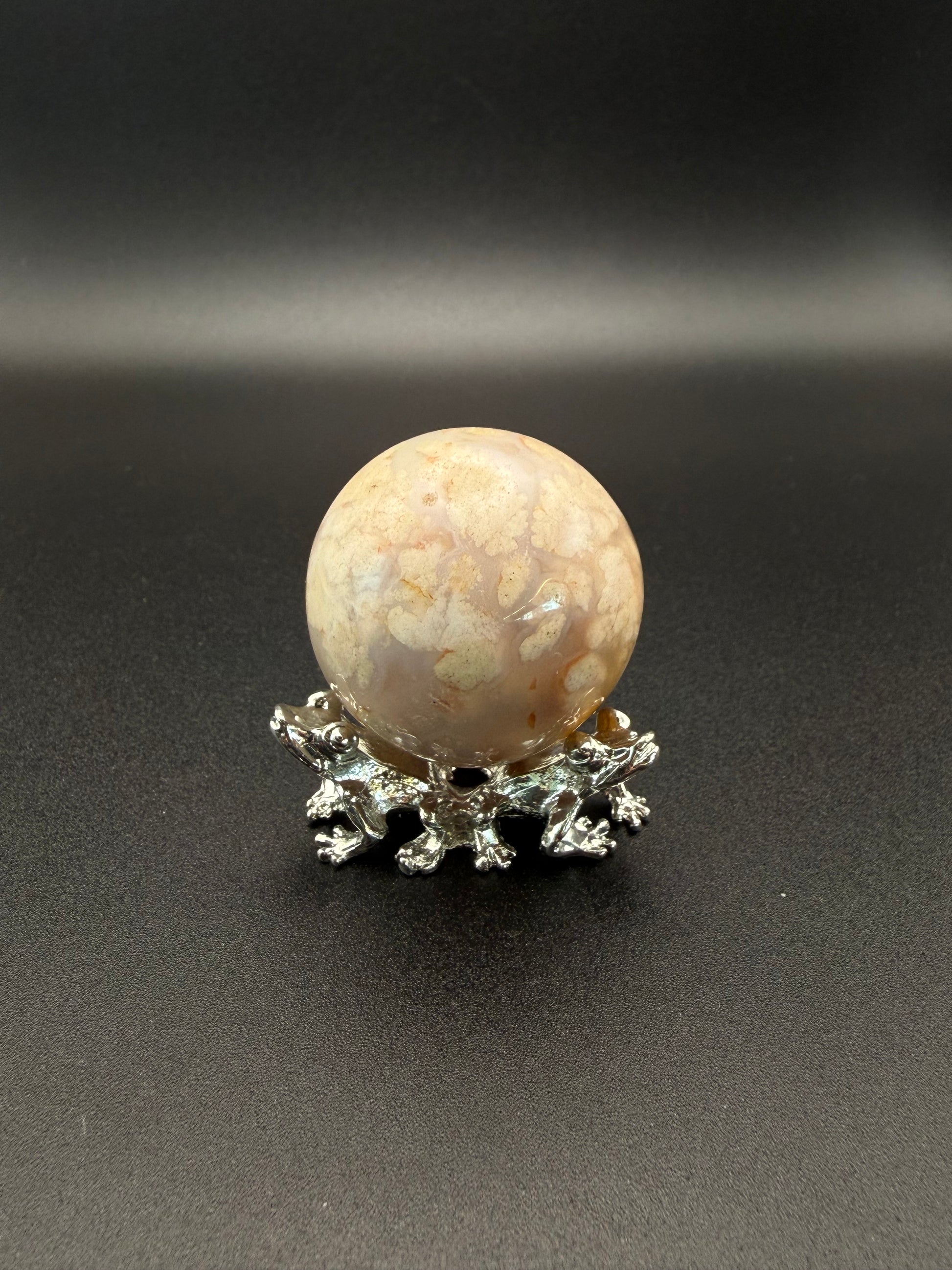 Flower agate polished crystal in the shape of a sphere.