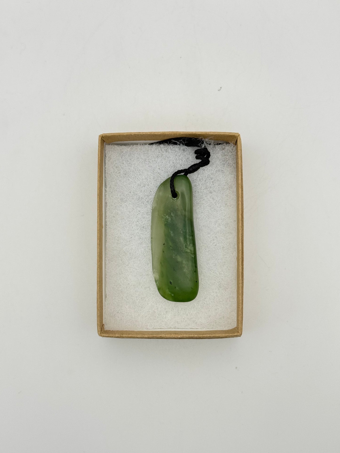 Green Jade pendant with string necklace.