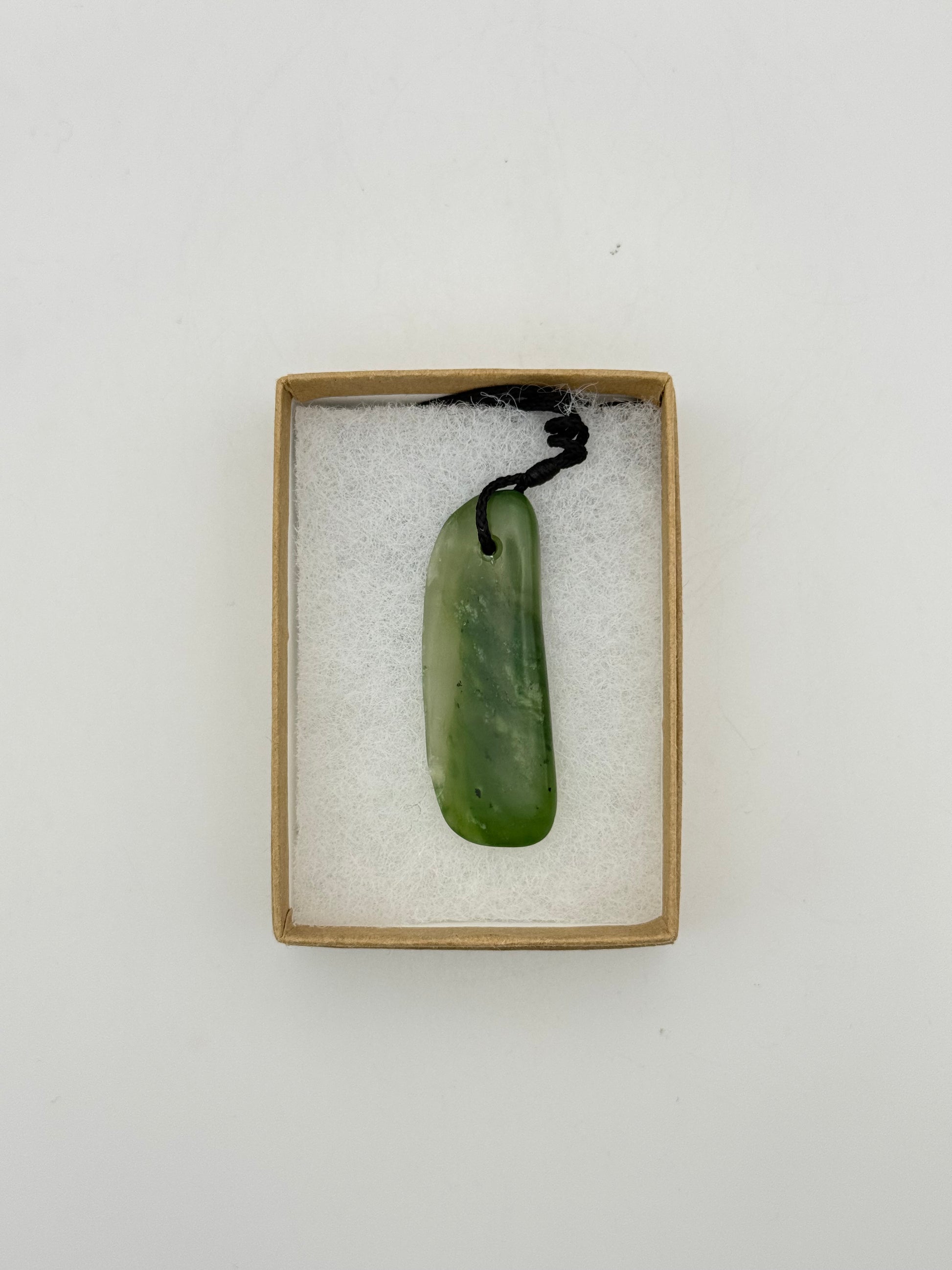 Green Jade pendant with string necklace.