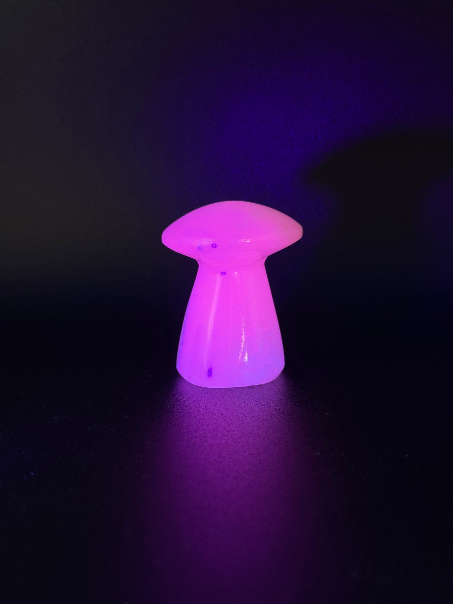 Polished pink calcite mushroom. Pink calcite glows under uv light.