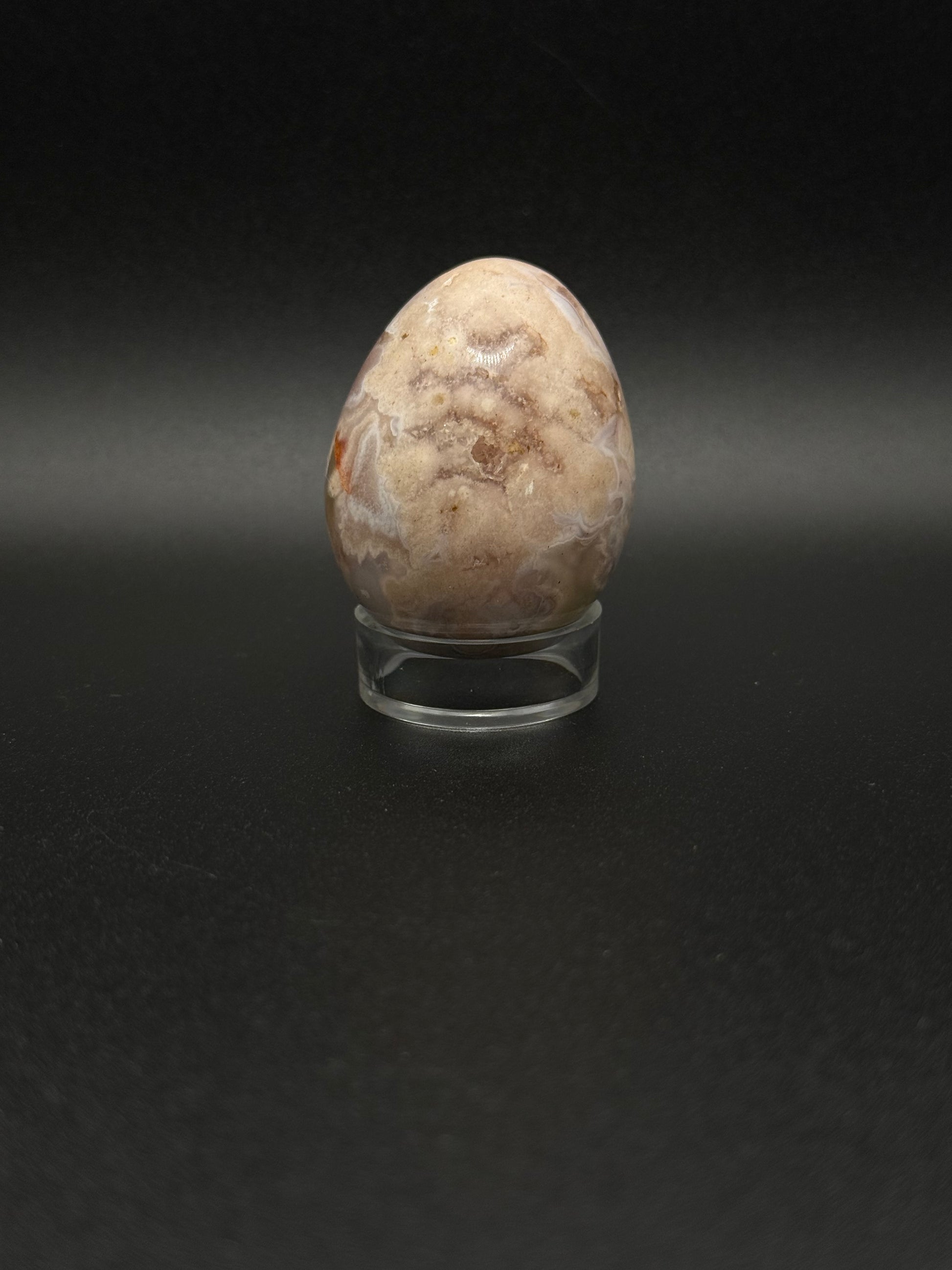 Polished flower agate crystal in the shape of an egg.