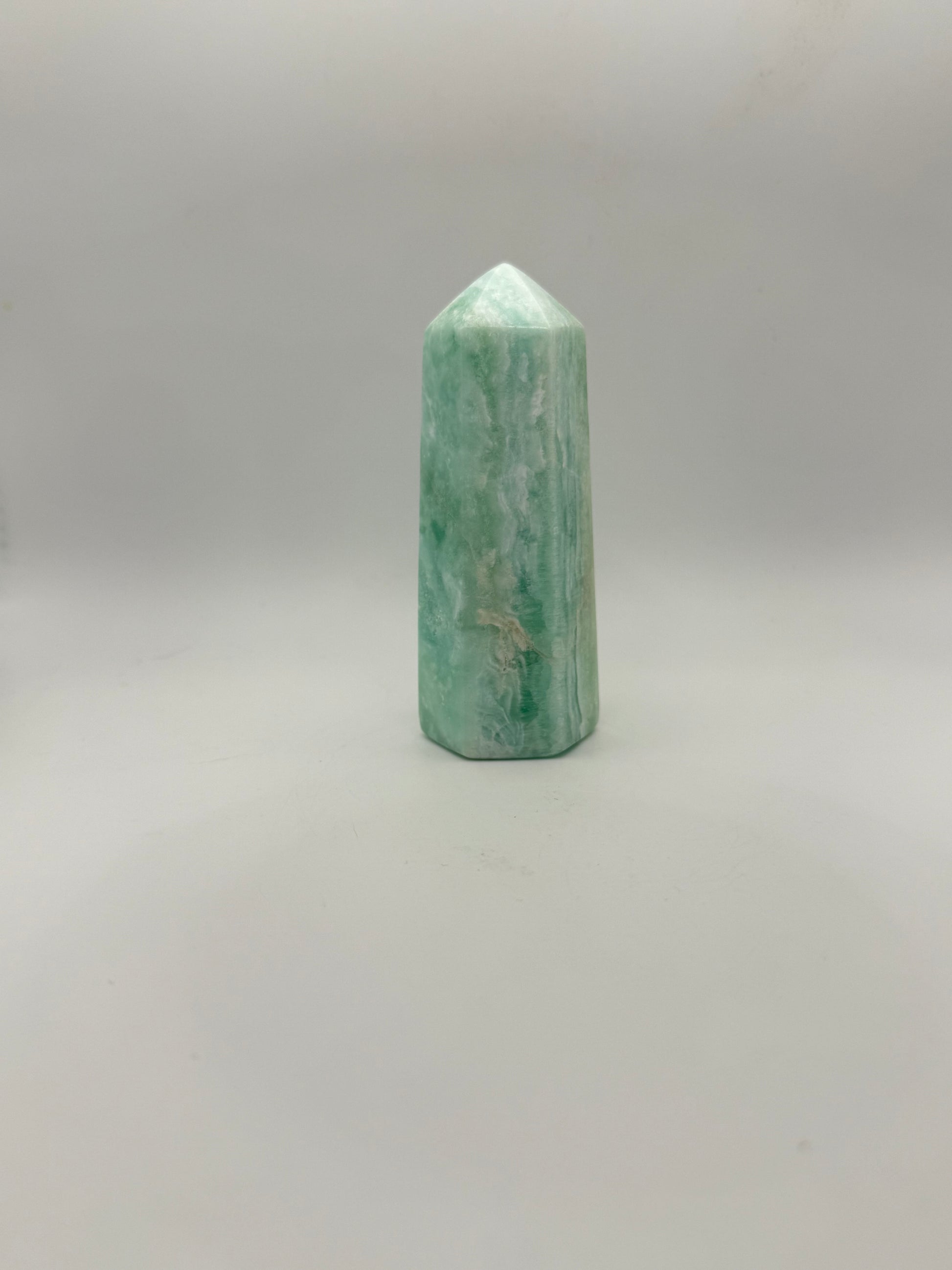 Caribbean Calcite polished six sided tower. A little over 4 inches tall.