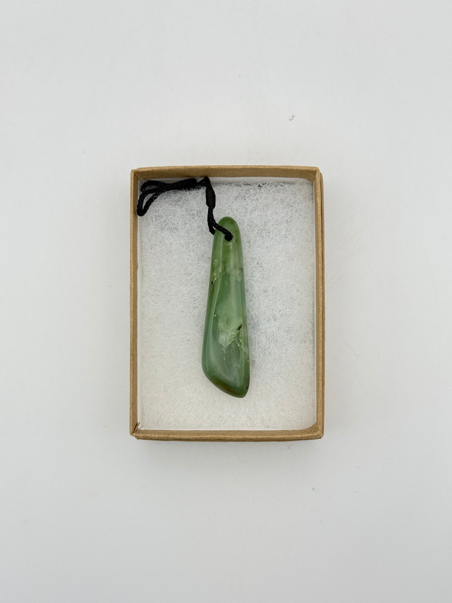 Green Jade pendant with string necklace.