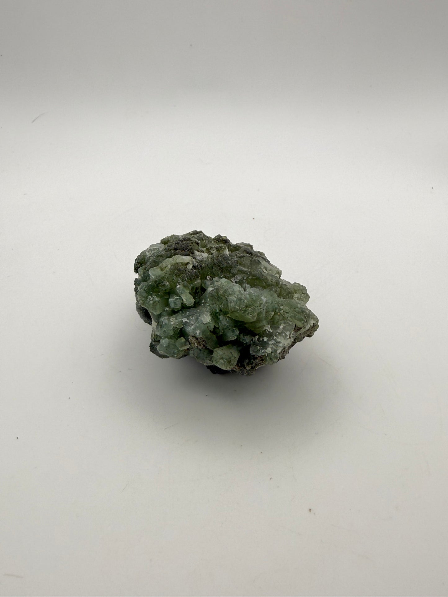 Raw Prehnite specimen with amazing green color.