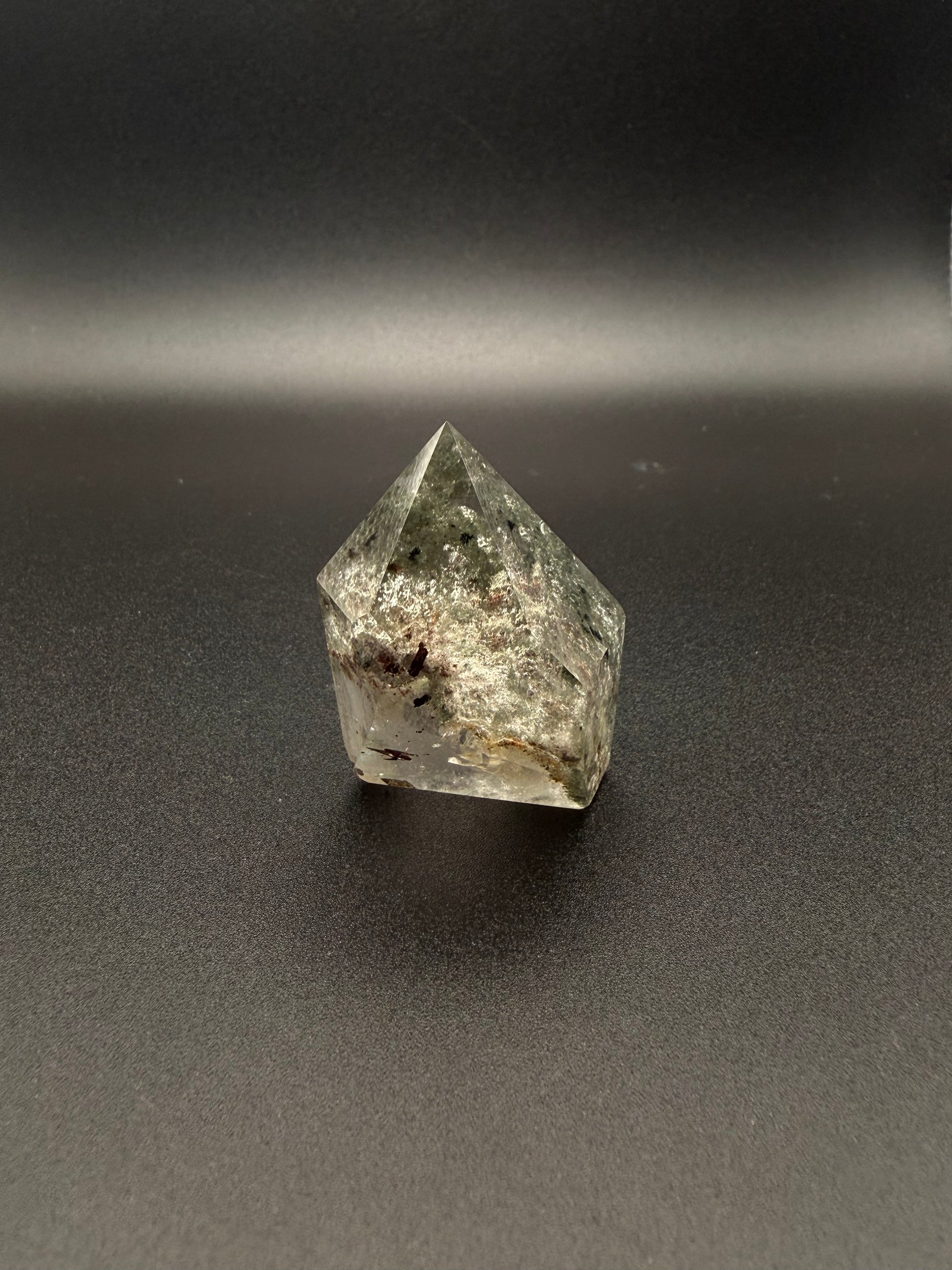 Polished garden quartz crystal tower with six sides.