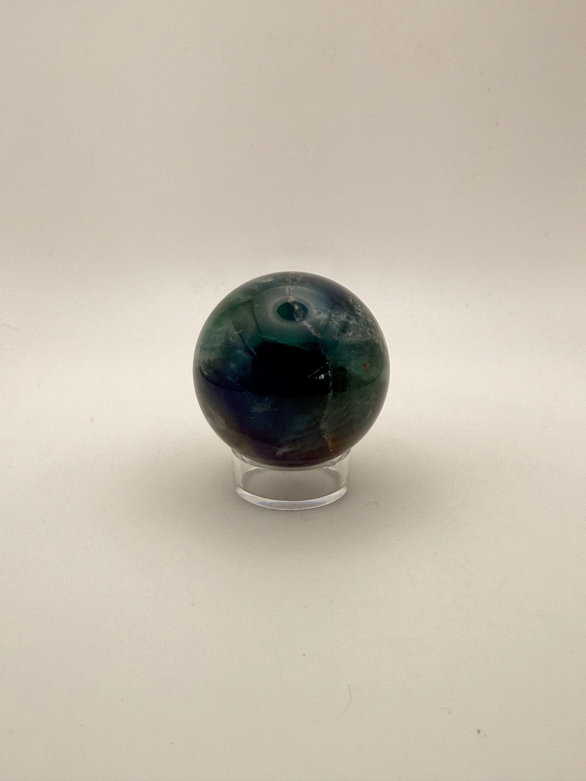 Rainbow Fluorite polished crystal sphere.