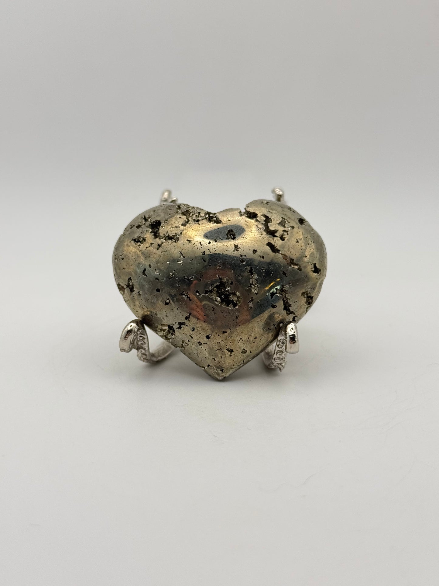 Polished pyrite crystal in the shape of a heart.