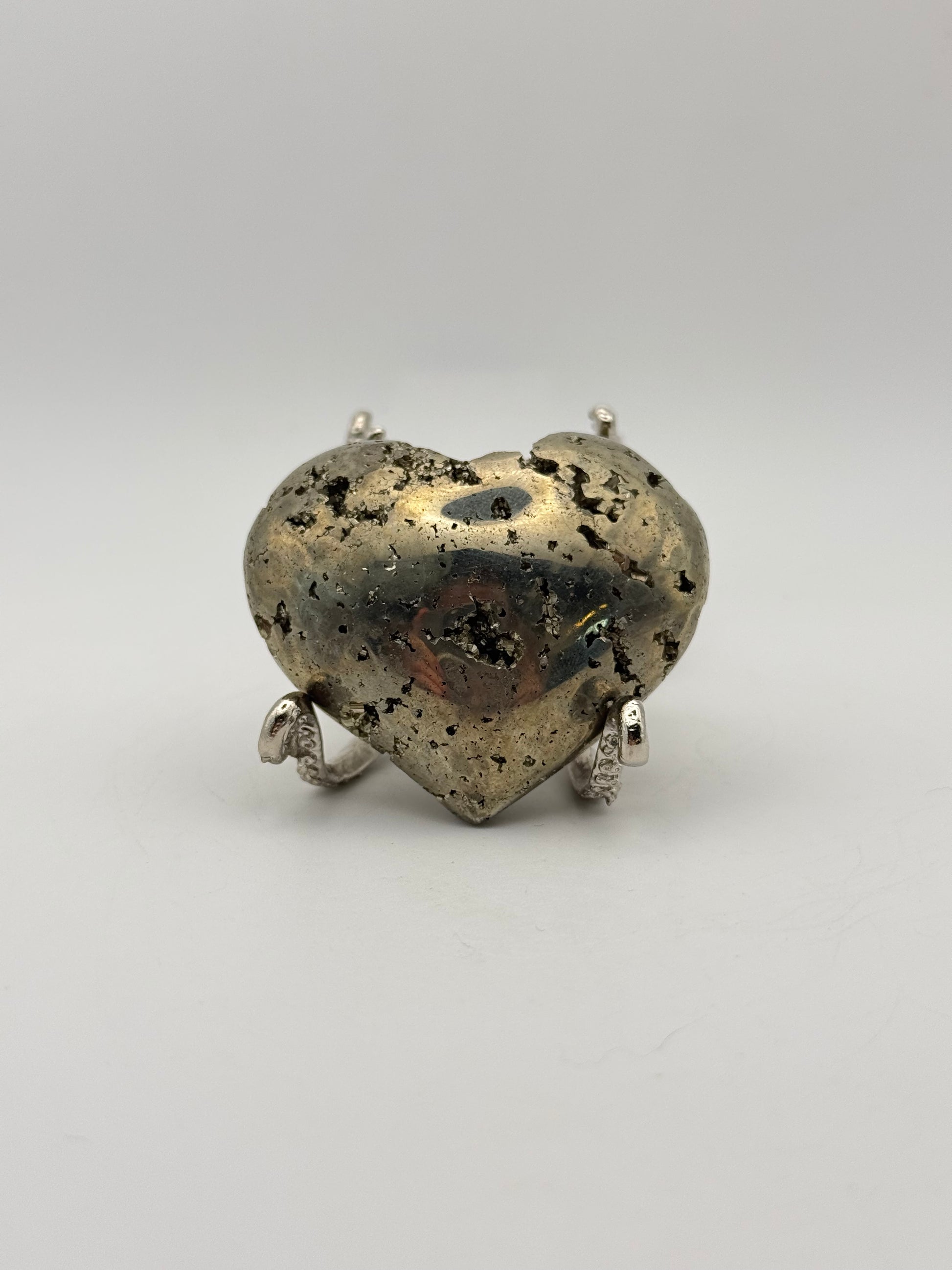 Polished pyrite crystal in the shape of a heart.