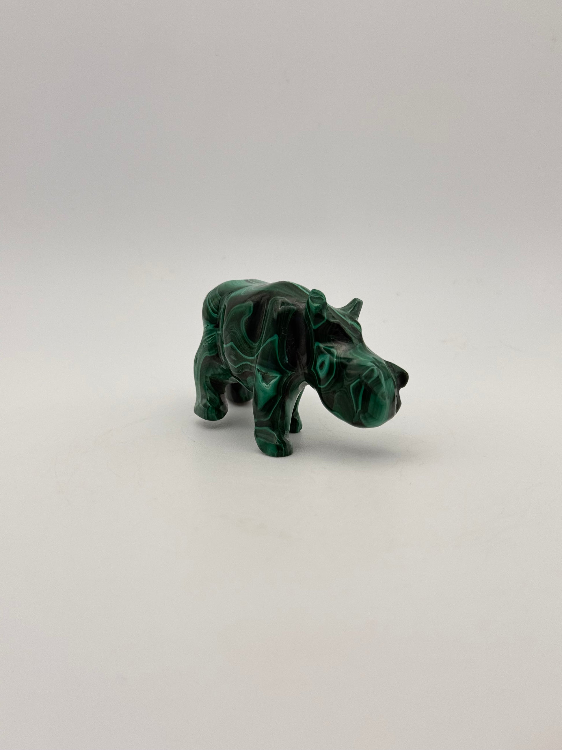 Vibrant green malachite stone carving of a rhino.