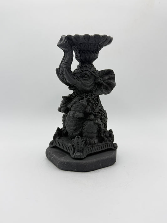 Shungite carving of an elephant that can be used as a candle holder.