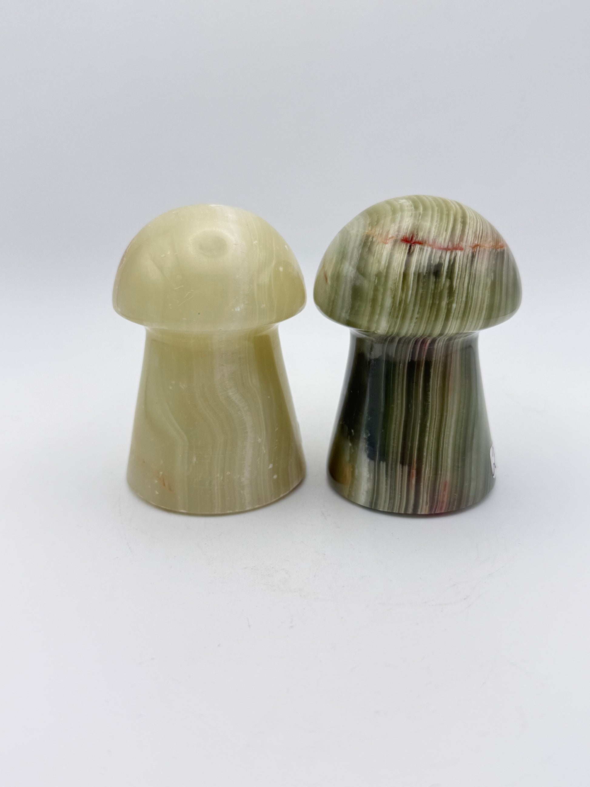 Two onyx mushroom-shaped stones.