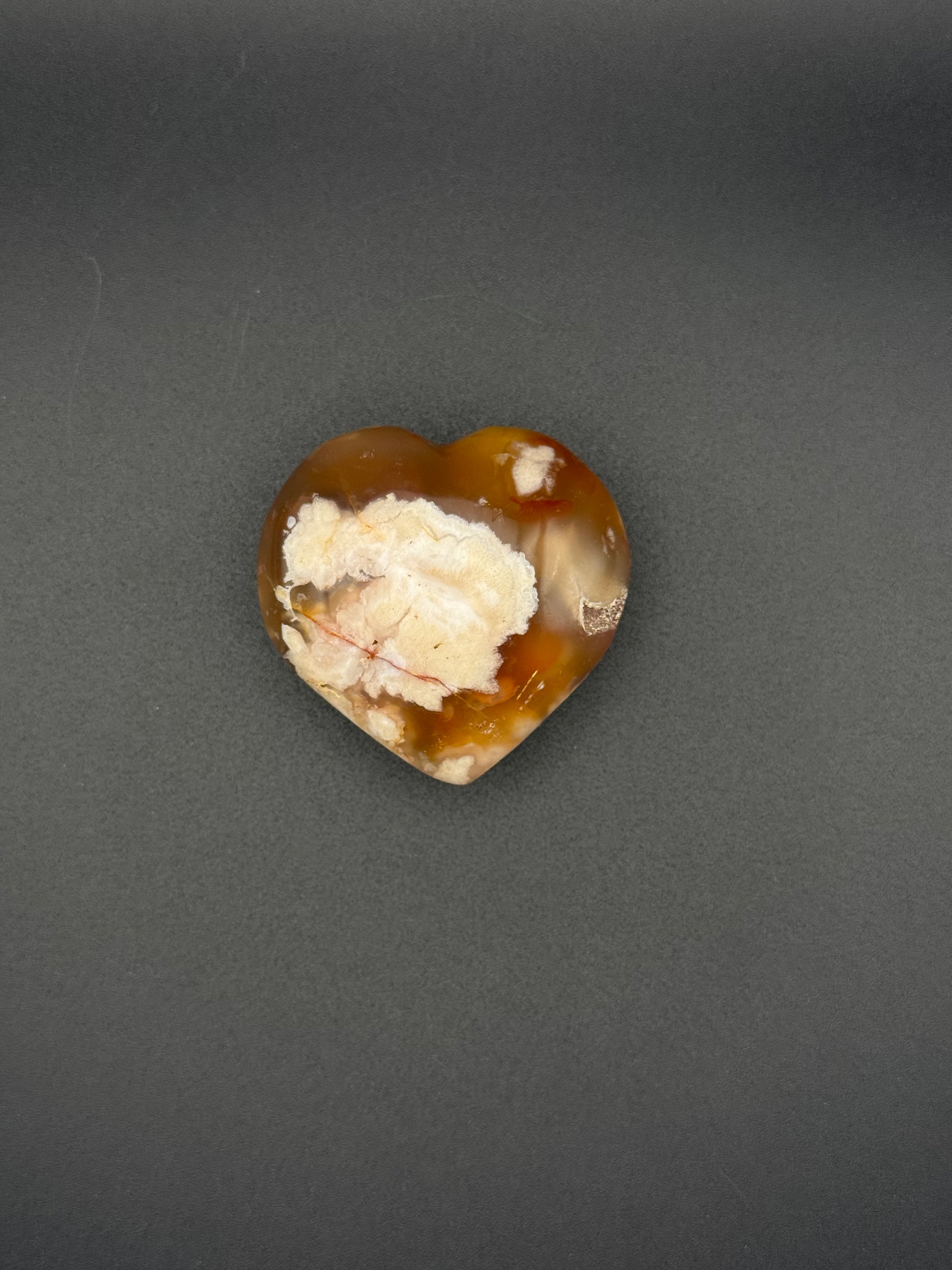 Flower Agate polished crystal in the shape of a heart.