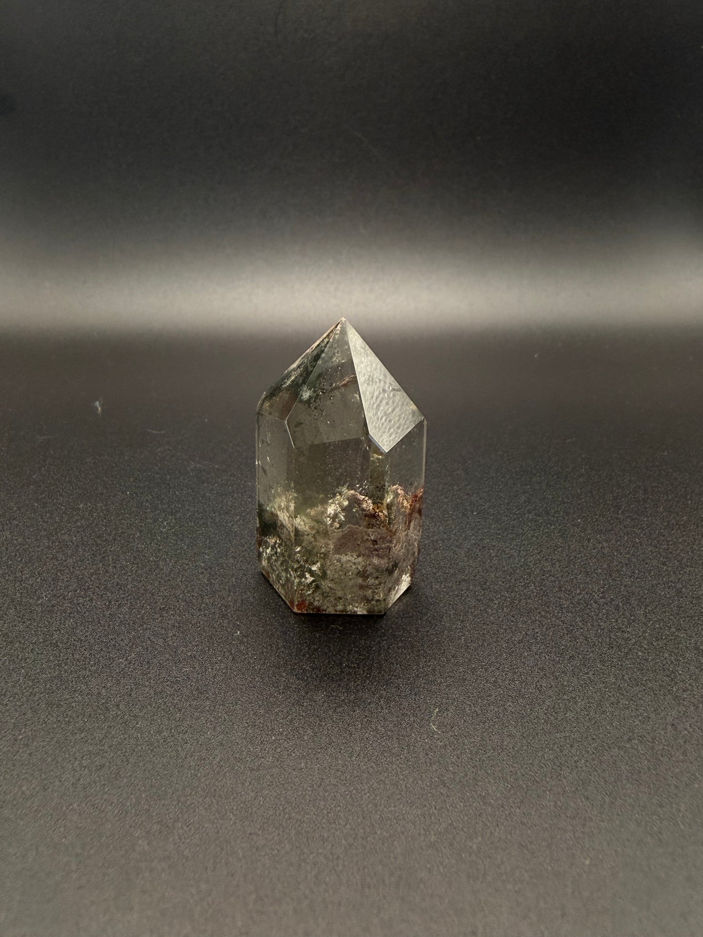 Polished garden quartz crystal tower with six sides.