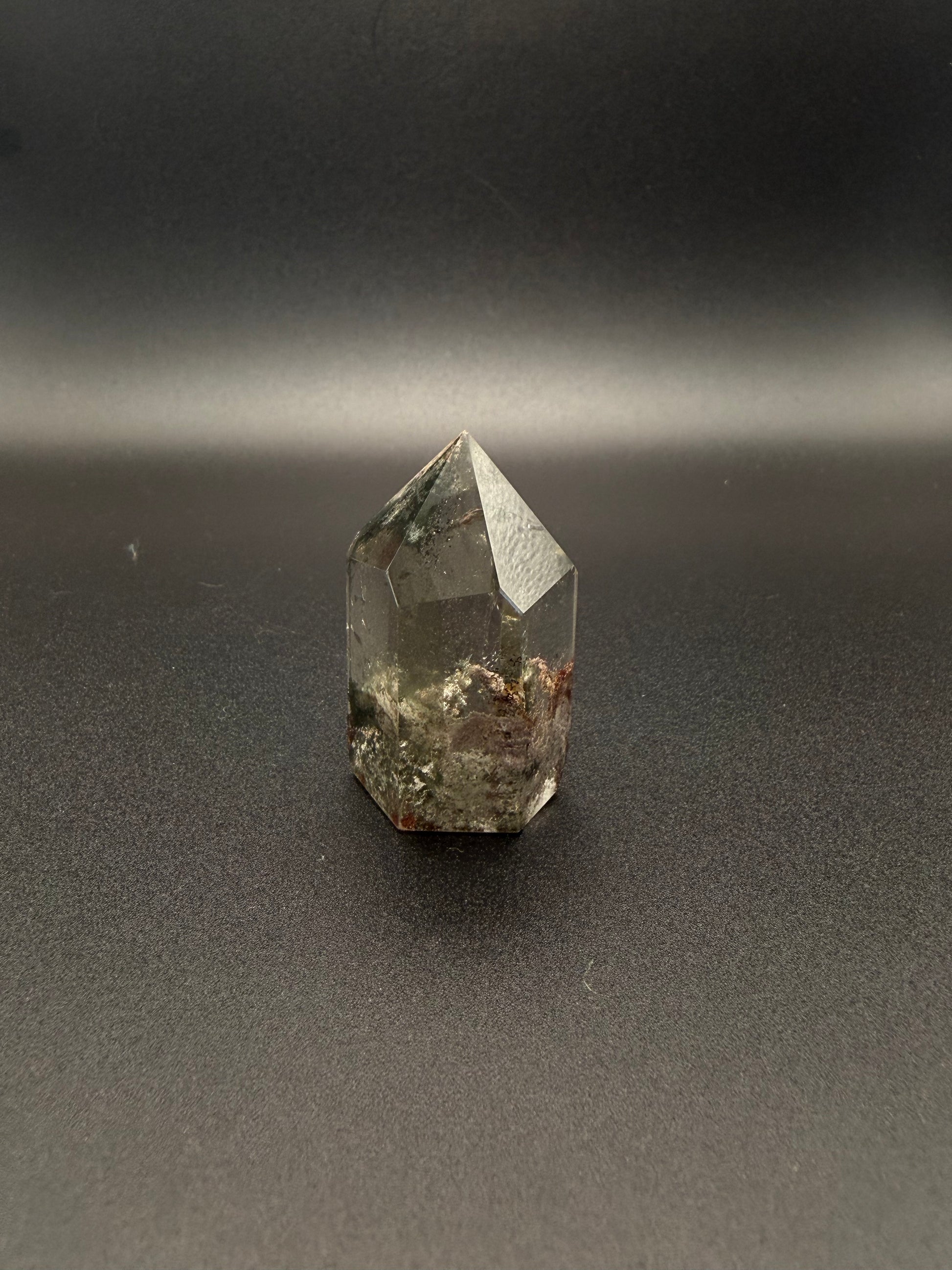 Polished garden quartz crystal tower with six sides.