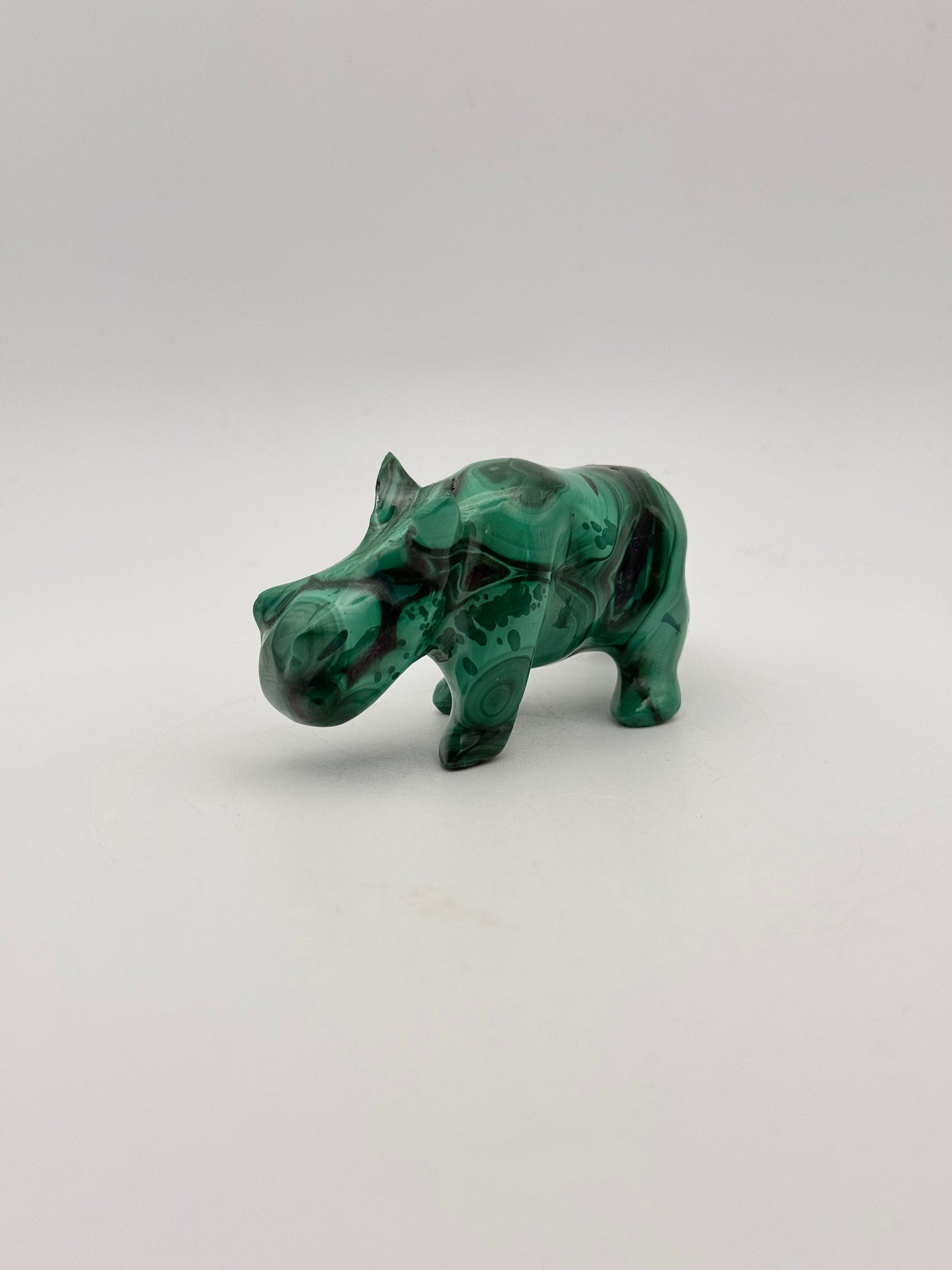 Vibrant green malachite carving of a rhino.