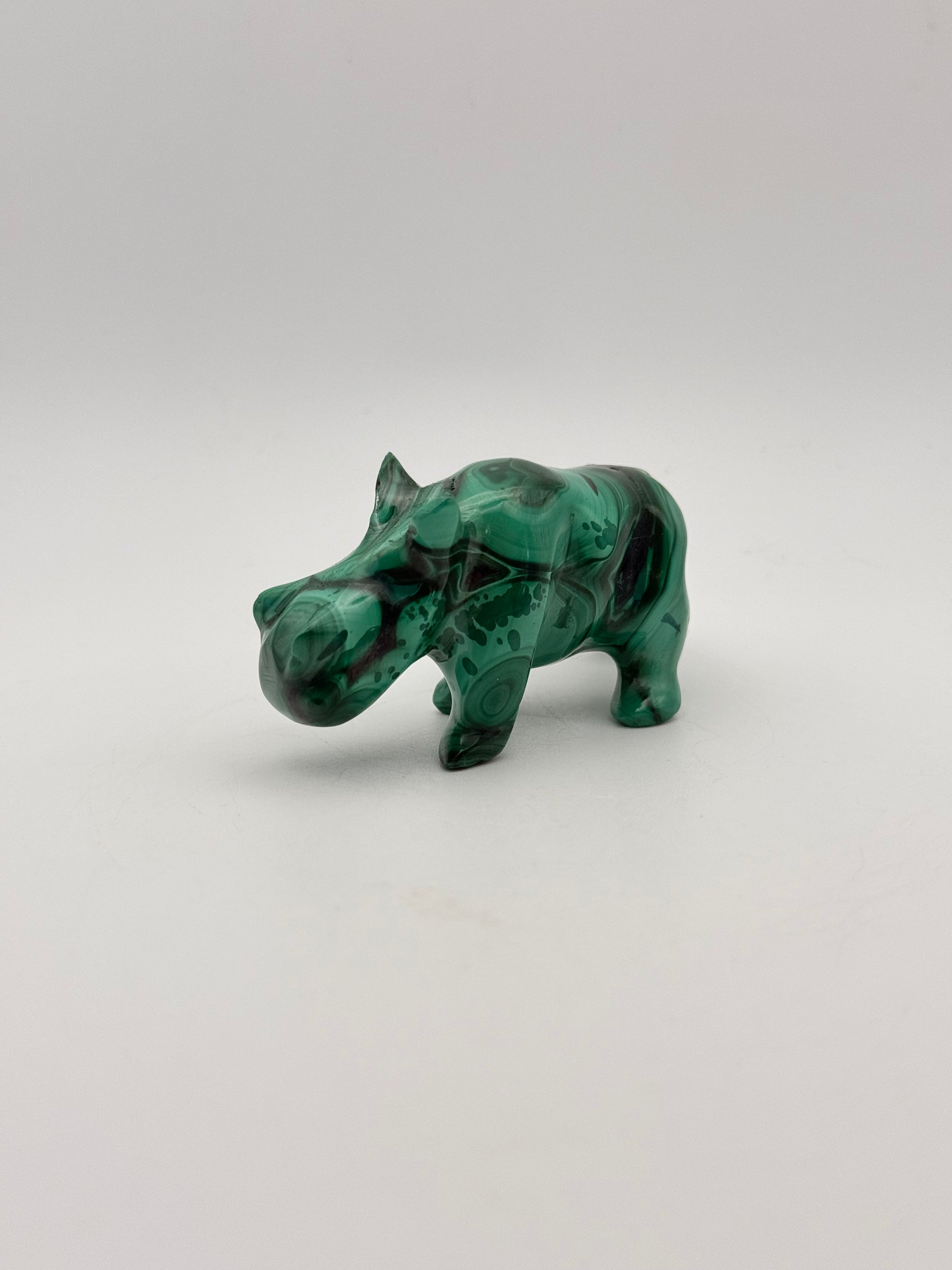 Vibrant green malachite carving of a rhino.