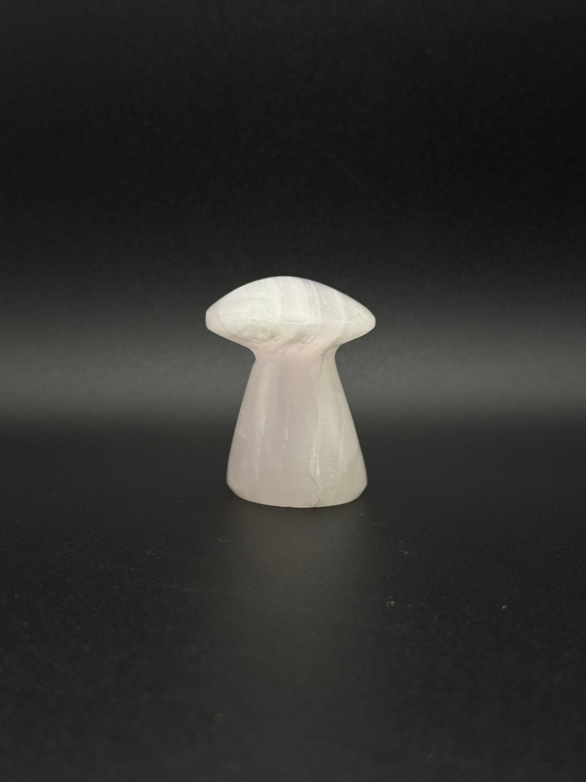 Polished pink calcite mushroom. Pink calcite glows under uv light.